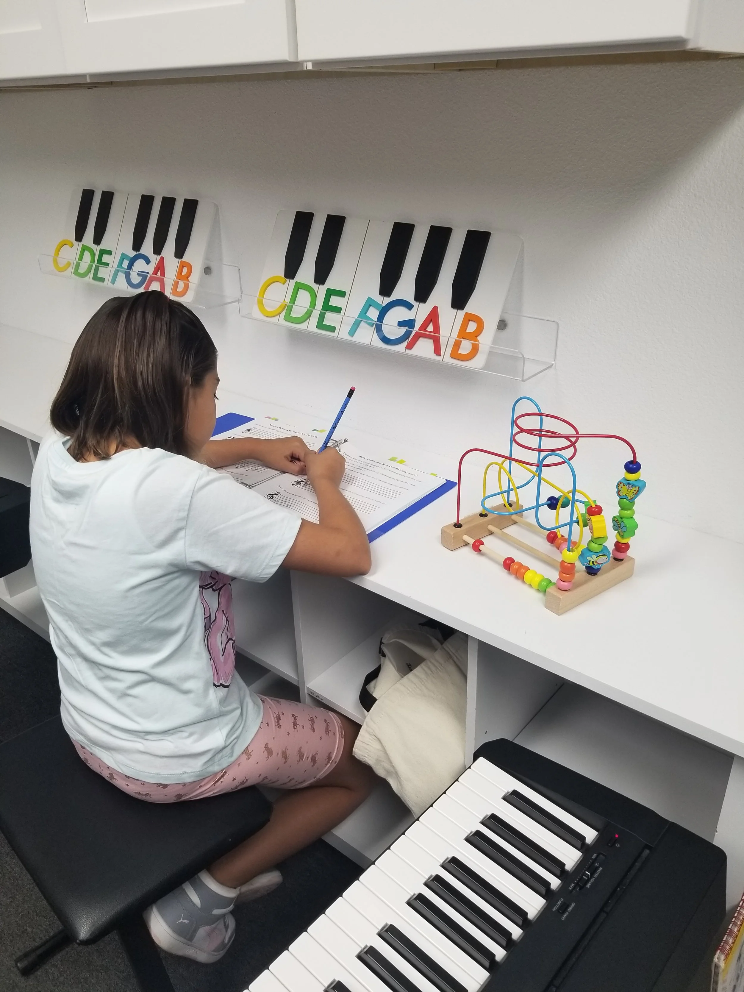 Music student writing in music workbook