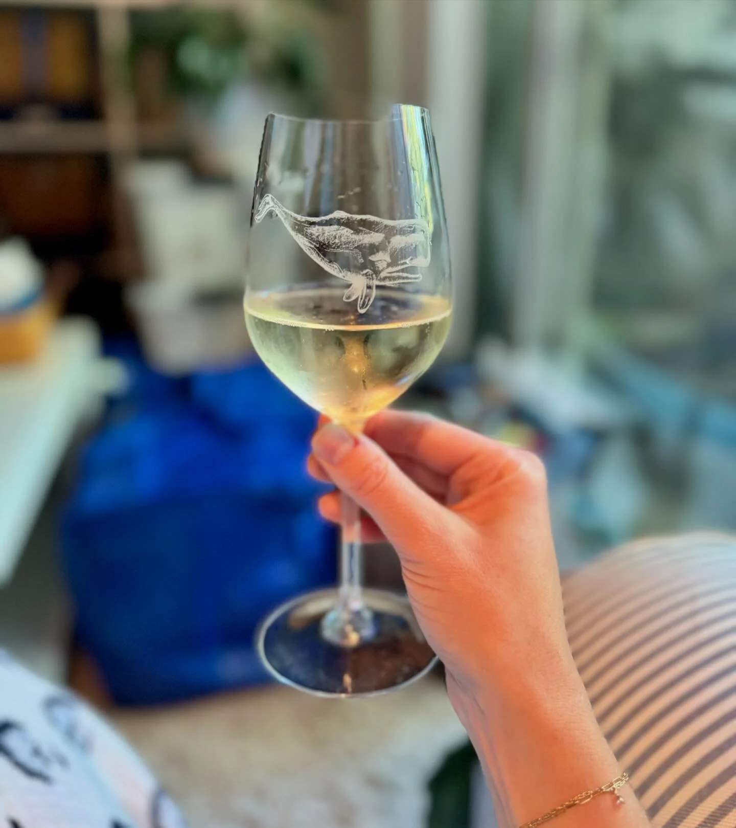 Champagne tastes batter from a glass with a 🐋. Especially when your apartment is now floor to ceiling moving boxes.