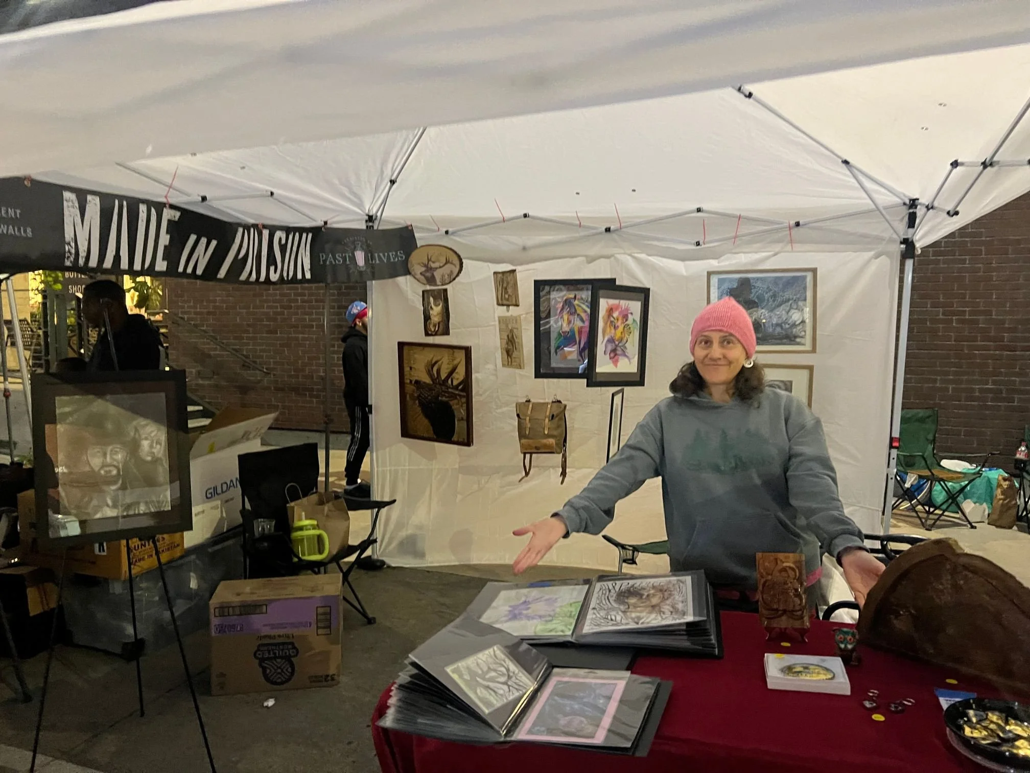 Inside the Past Lives Prison Outreach Guild's booth featuring work by incarcerated artists