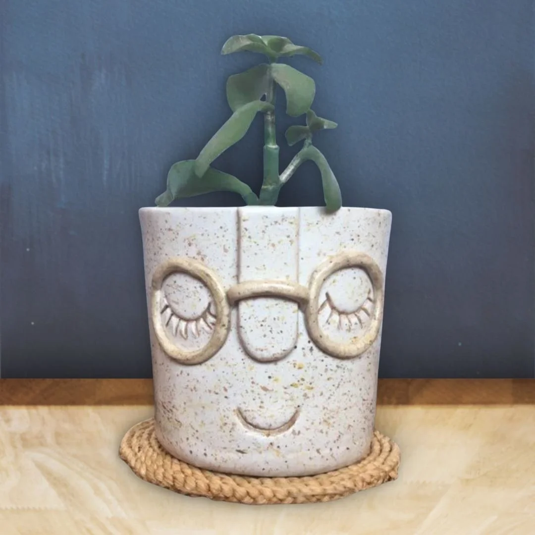 Hand-made ceramics planter with a smiley face