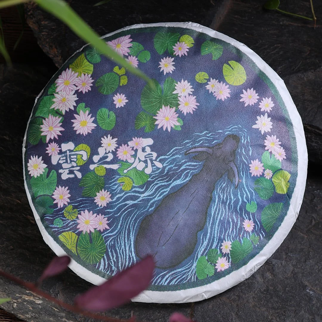A hand illustrated ox swims through a river, pushing away lilypads and lily flowers, used as a wrapper for Chinese tea cake 
