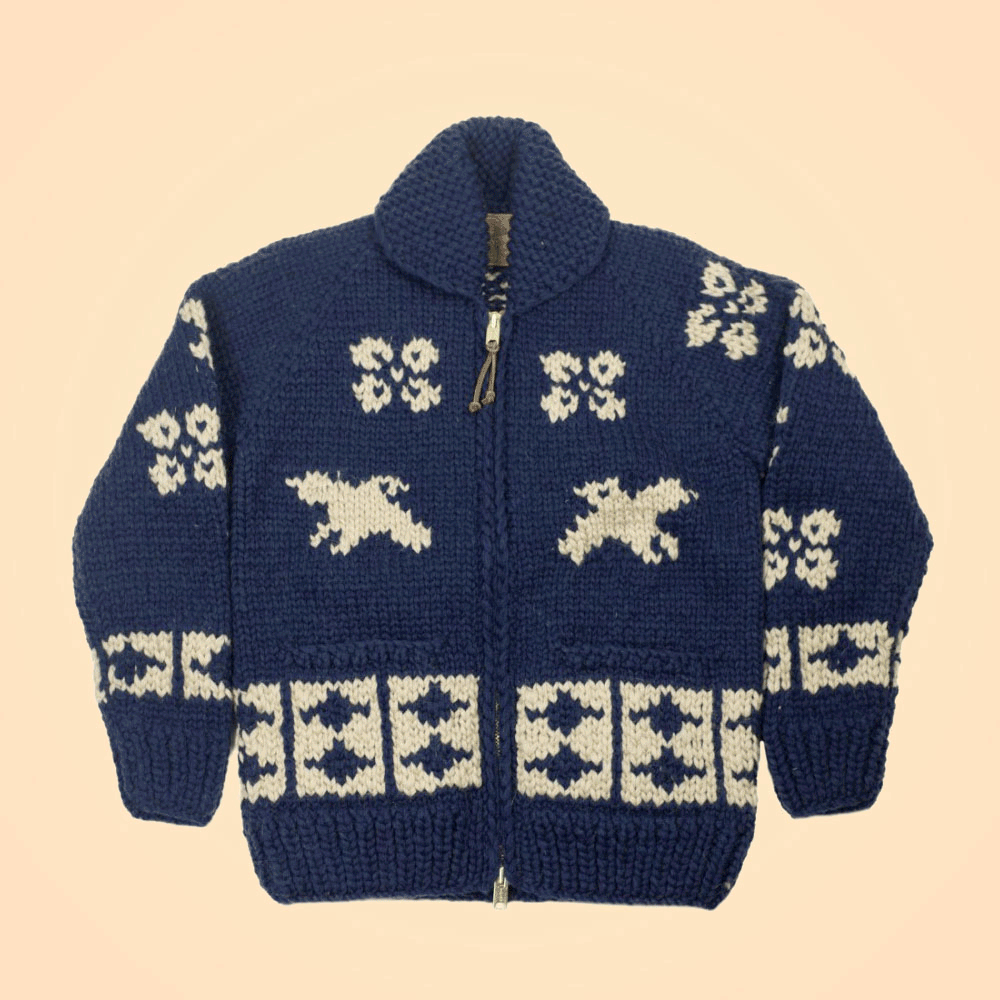 A traditional First Peoples' cowichan sweater designed by Bang featuring traditional Japanese motifs of swallows, cherry blossoms, abacus, and a crane swooping downward on the back
