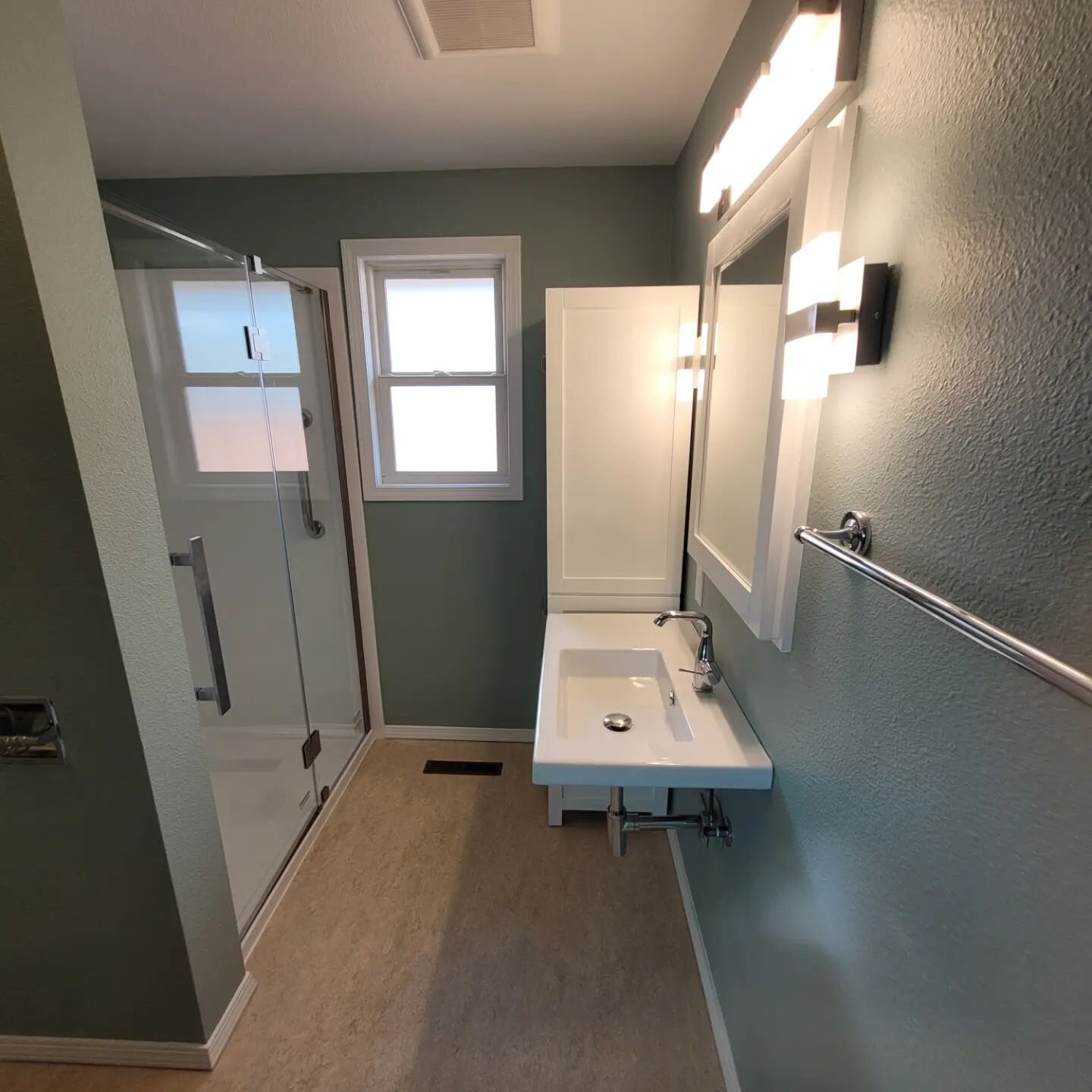 Swipe for the before! 
Before and after an 1980's bathroom update. The client requested to be wheelchair accessible.  Wall color is @shermanwillians quietude.

#bathroomdesign #beforeandafter #sherwinwilliams #bathroomremodel 
#wheelchairfriendly #cu