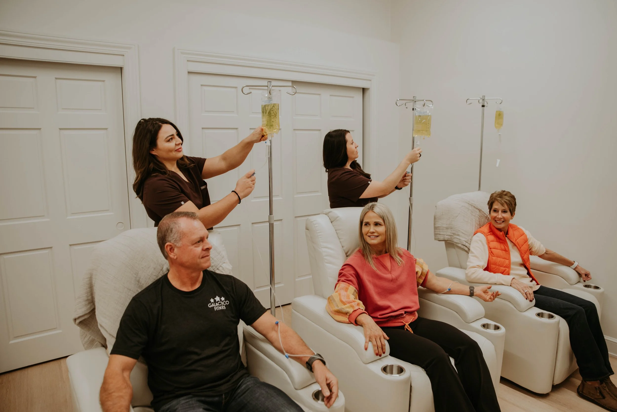 Patients receiving IV therapy infusion at Atlas Health + Wellness for hydration and immune support.