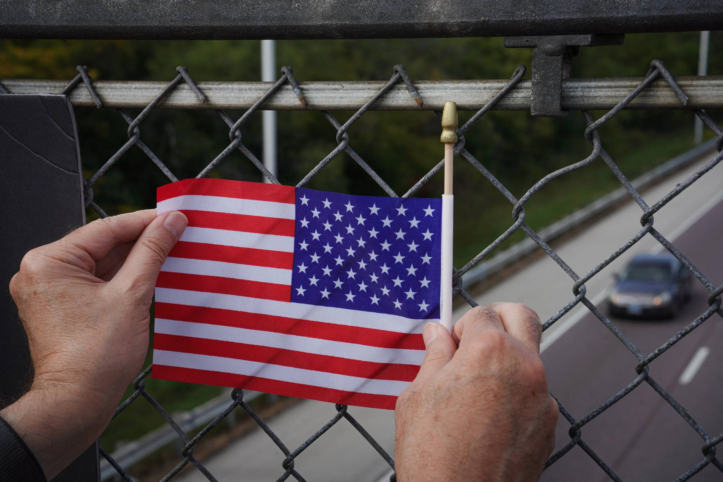 Demonstrators also held up the American flag toward the I-94.