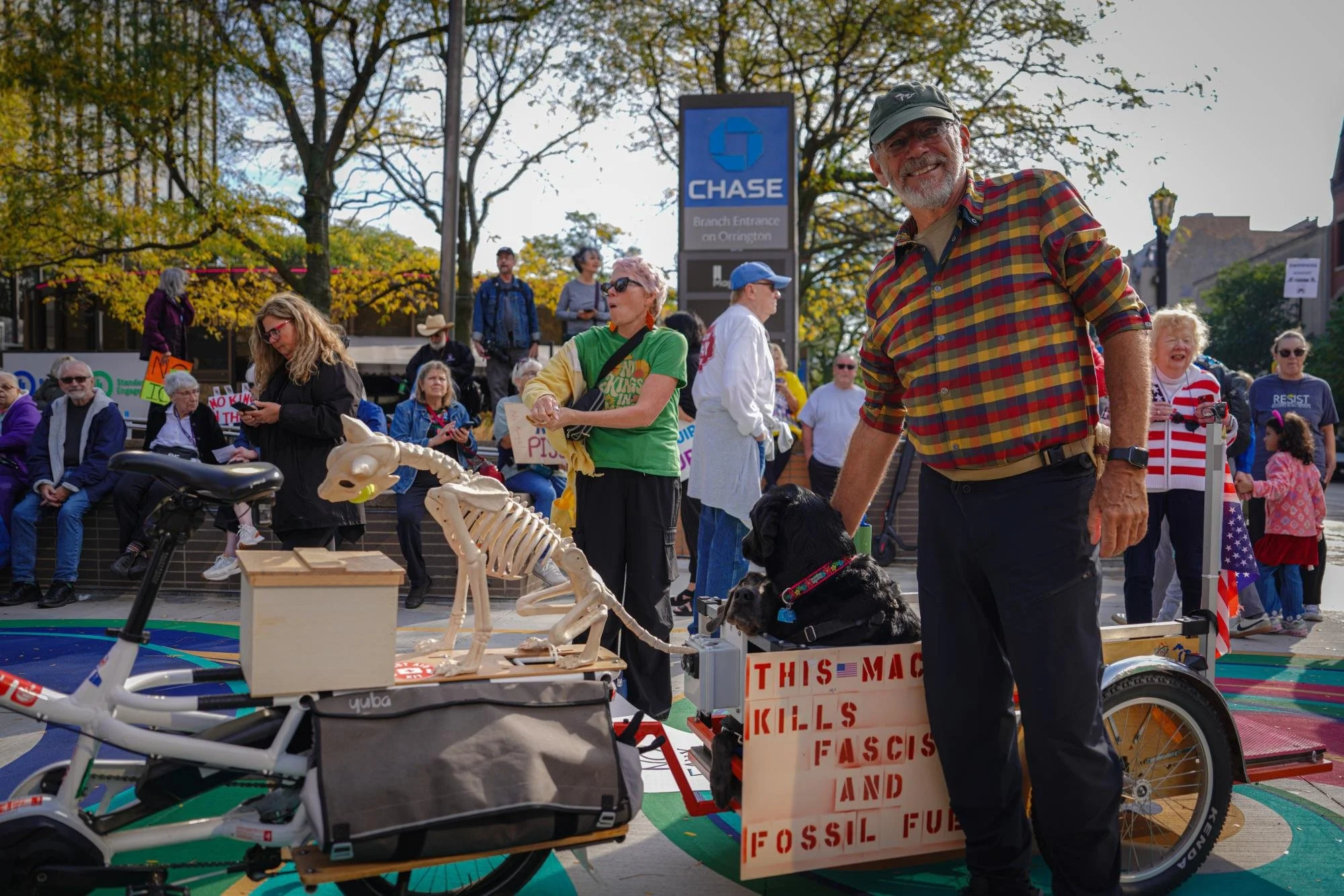 Second Ward resident Benjamin Schapiro pets his dogs Shadow and Ash. Schapiro said that he brought his dogs to help people release endorphins during the protest as well as work on Shadow and Ash’s socialization skills. 