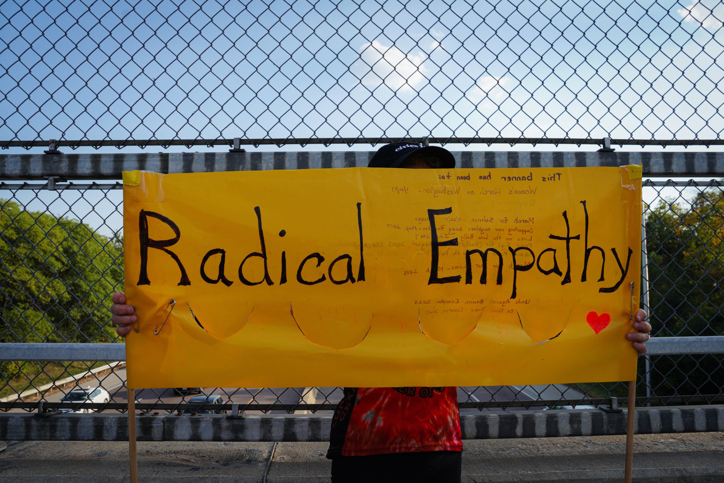 People held up signs toward I-94 that said phrases such as “Radical Empathy,” “Stop Fascism” and “No Kings.”
