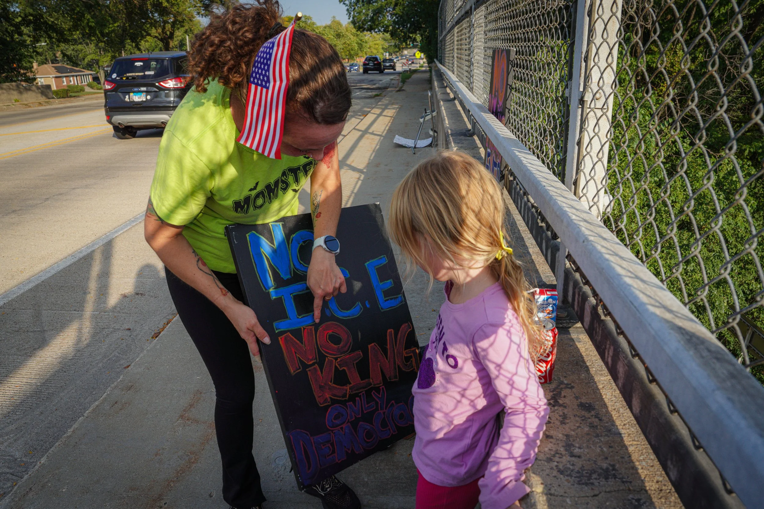 Morton Grove resident Jaclyn Jennetten joined the demonstration with her daughter, Olivia. The six-year-old and her mother held up signs that they had made. 