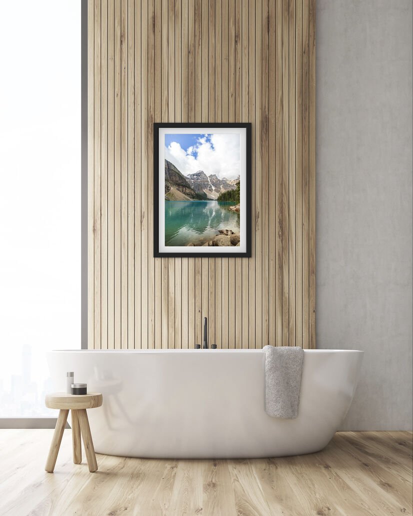 Framed Moraine Lake Banff National Park landscape wall art displayed above a freestanding bathtub in a modern bathroom