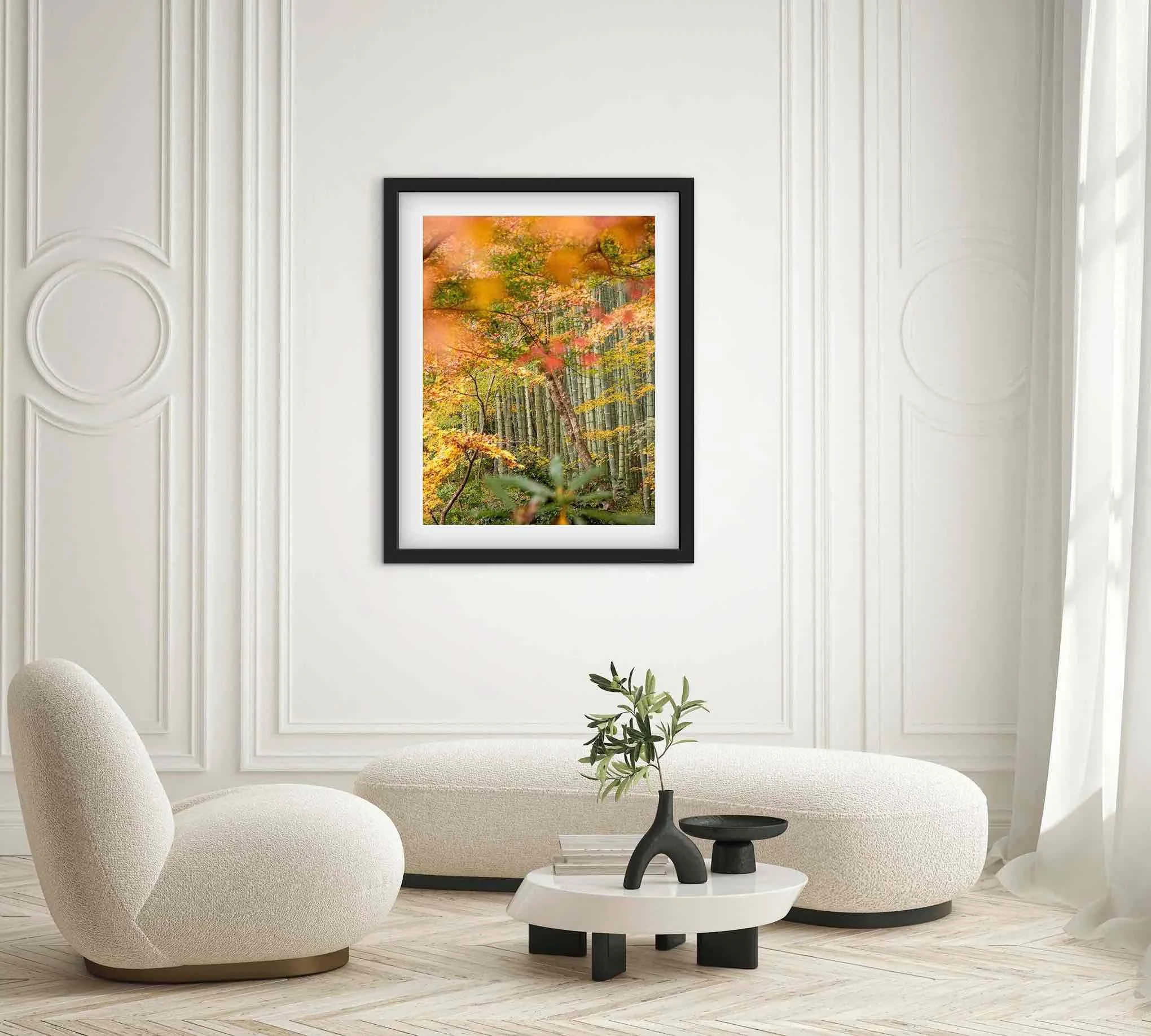 Framed Kyoto Japan autumn foliage and bamboo forest photography print displayed in a modern living room