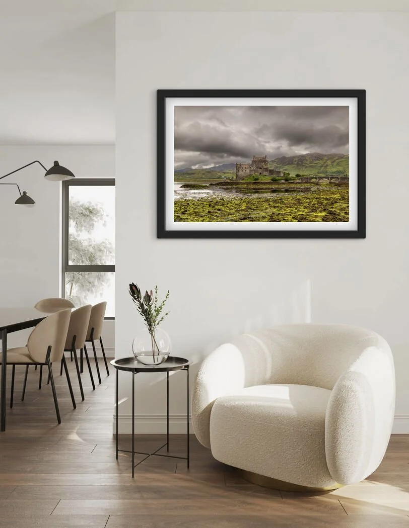 Framed Eilean Donan Castle Scotland landscape photography print displayed on a light wall in a modern living room