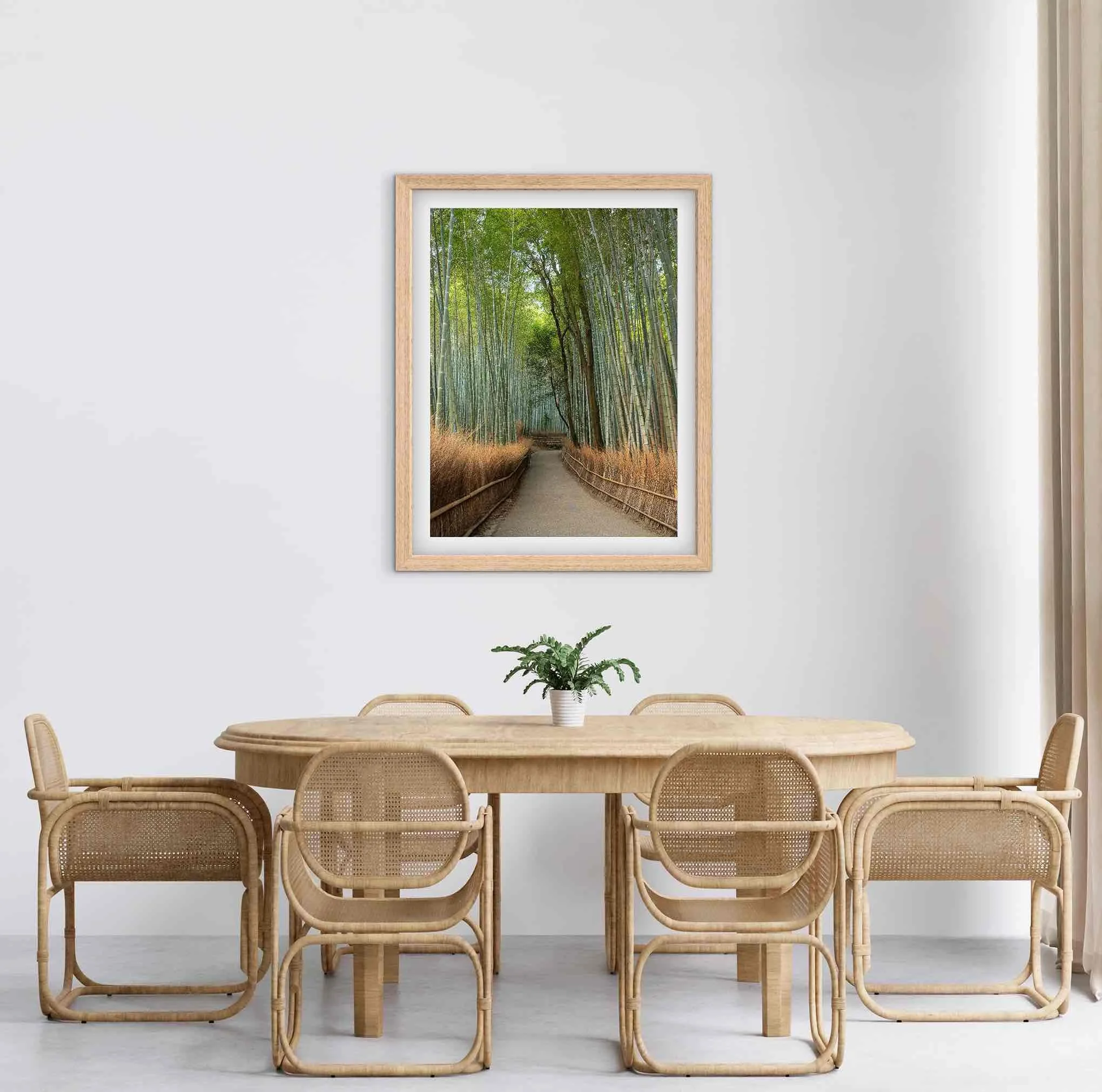 Framed Arashiyama Bamboo Grove Kyoto Japan bamboo forest photography print displayed above a wooden dining table in a modern dining room