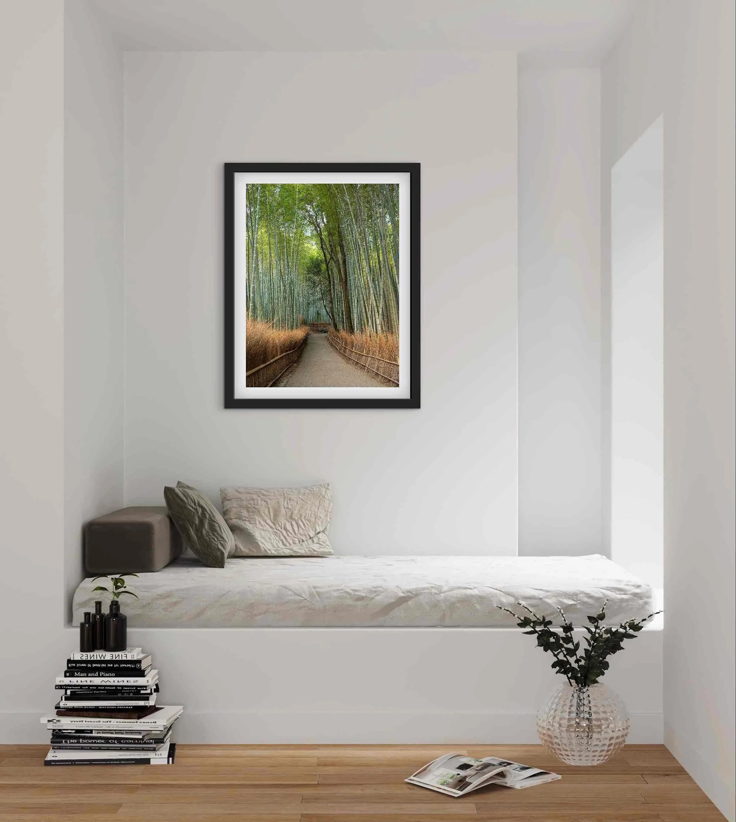 Framed Arashiyama Bamboo Grove Kyoto Japan bamboo forest photography print displayed above a bed in a calm minimalist bedroom