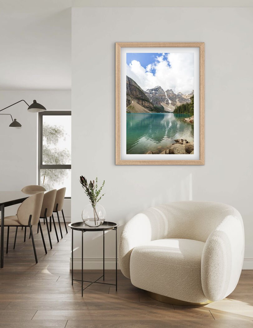 Framed Moraine Lake Canadian Rockies photography print displayed on a light wall in a modern living room
