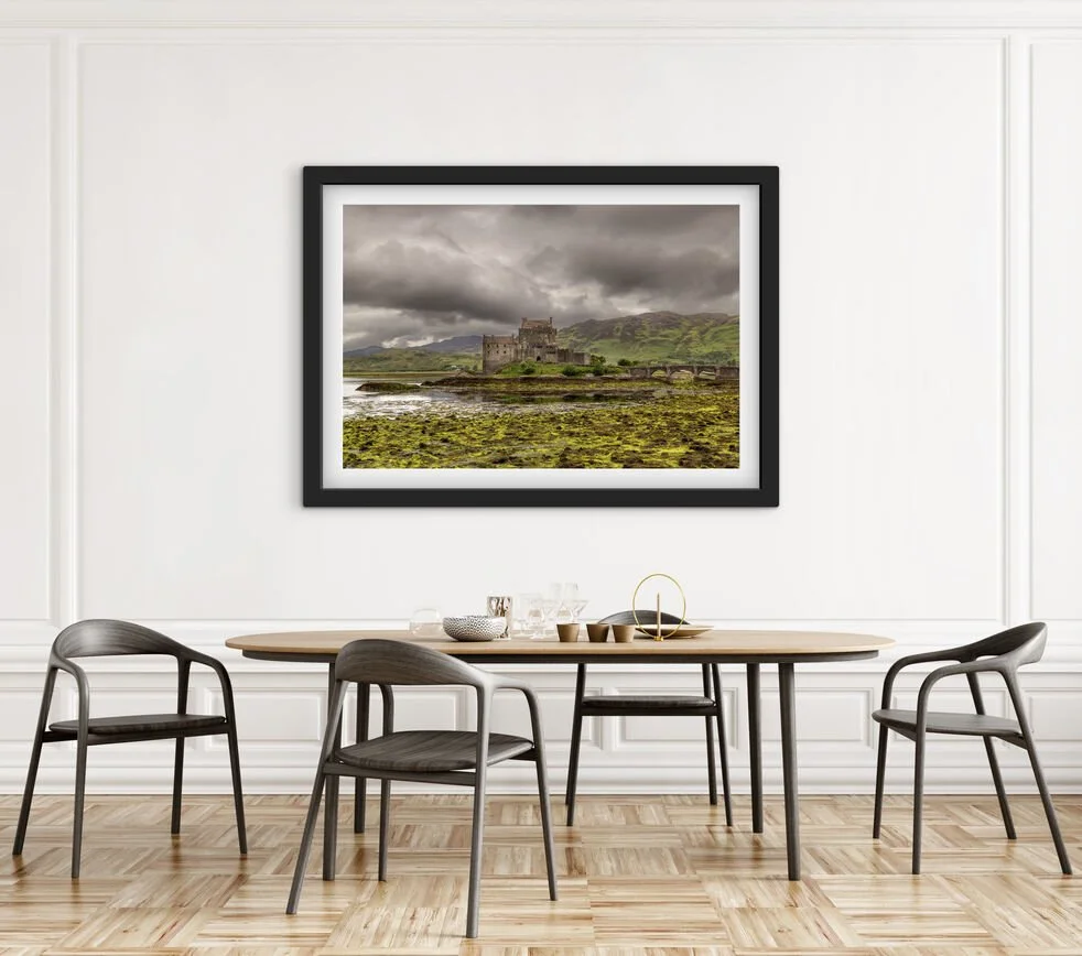 Framed Eilean Donan Castle Scotland wall art displayed above a dining table in a contemporary dining room