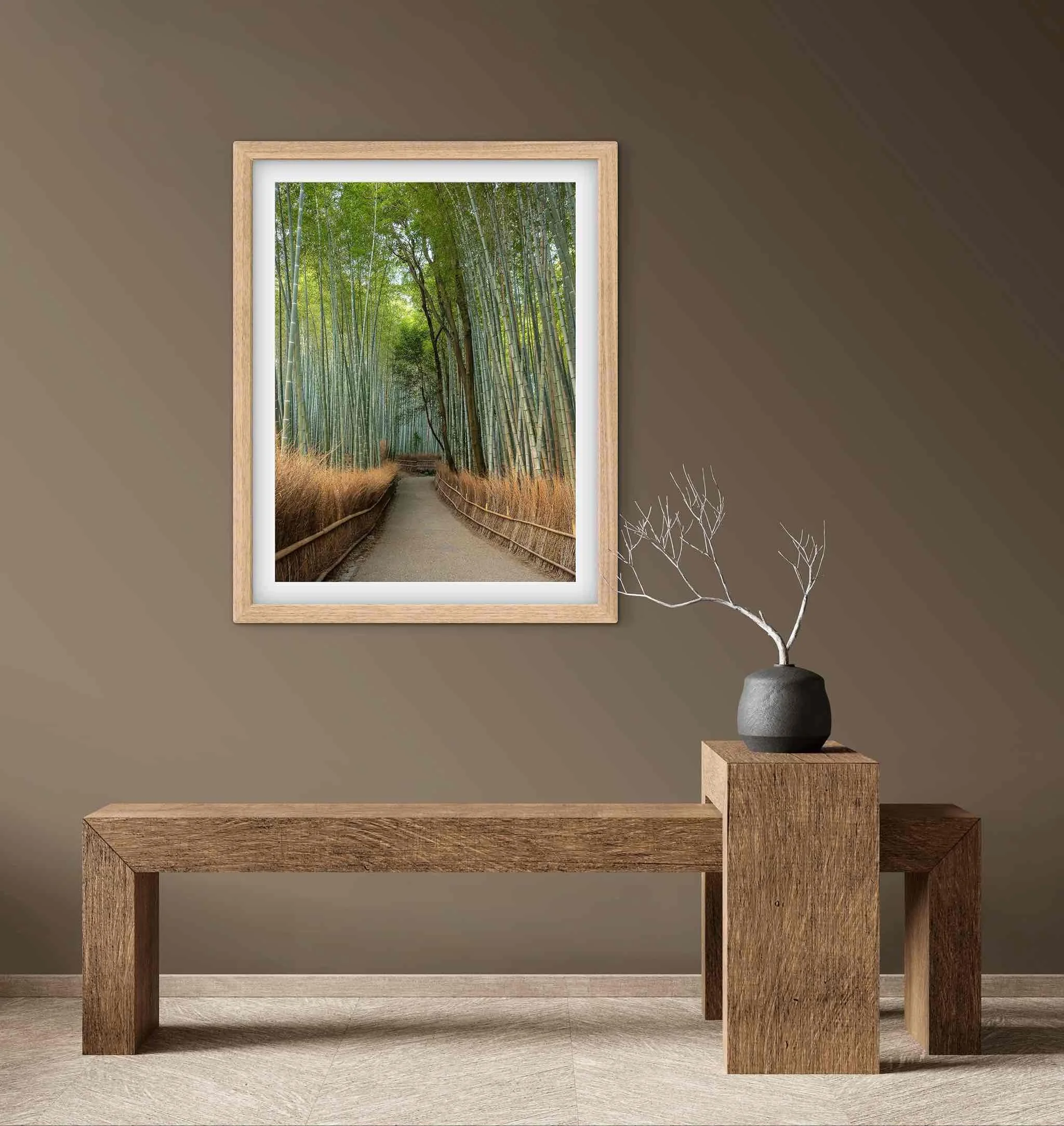 Framed Arashiyama Bamboo Grove Kyoto Japan bamboo forest wall art displayed above a wooden bench in a minimalist interior
