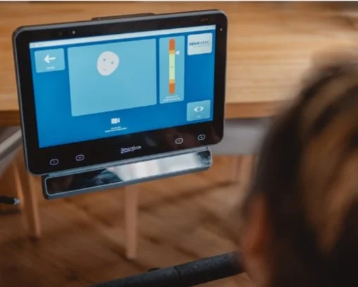 An eye-gaze communication device displaying a smiley face, a color intensity scale, and a button labeled 'Start'.
