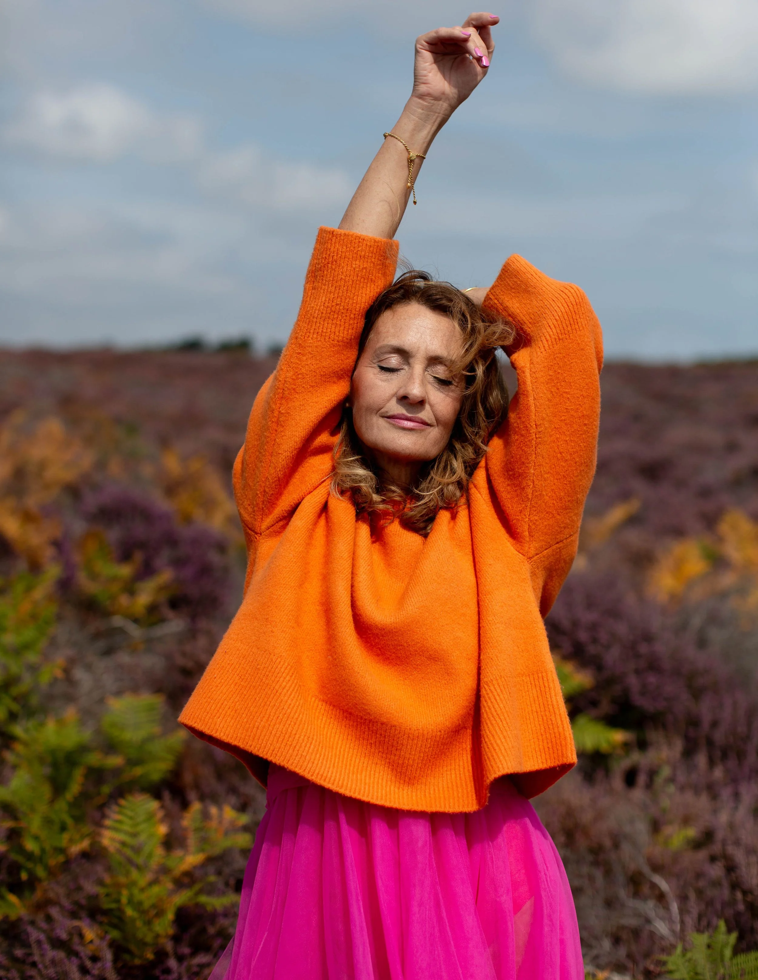 Meryl by Rossanna Novella orange jumper stretching.jpg