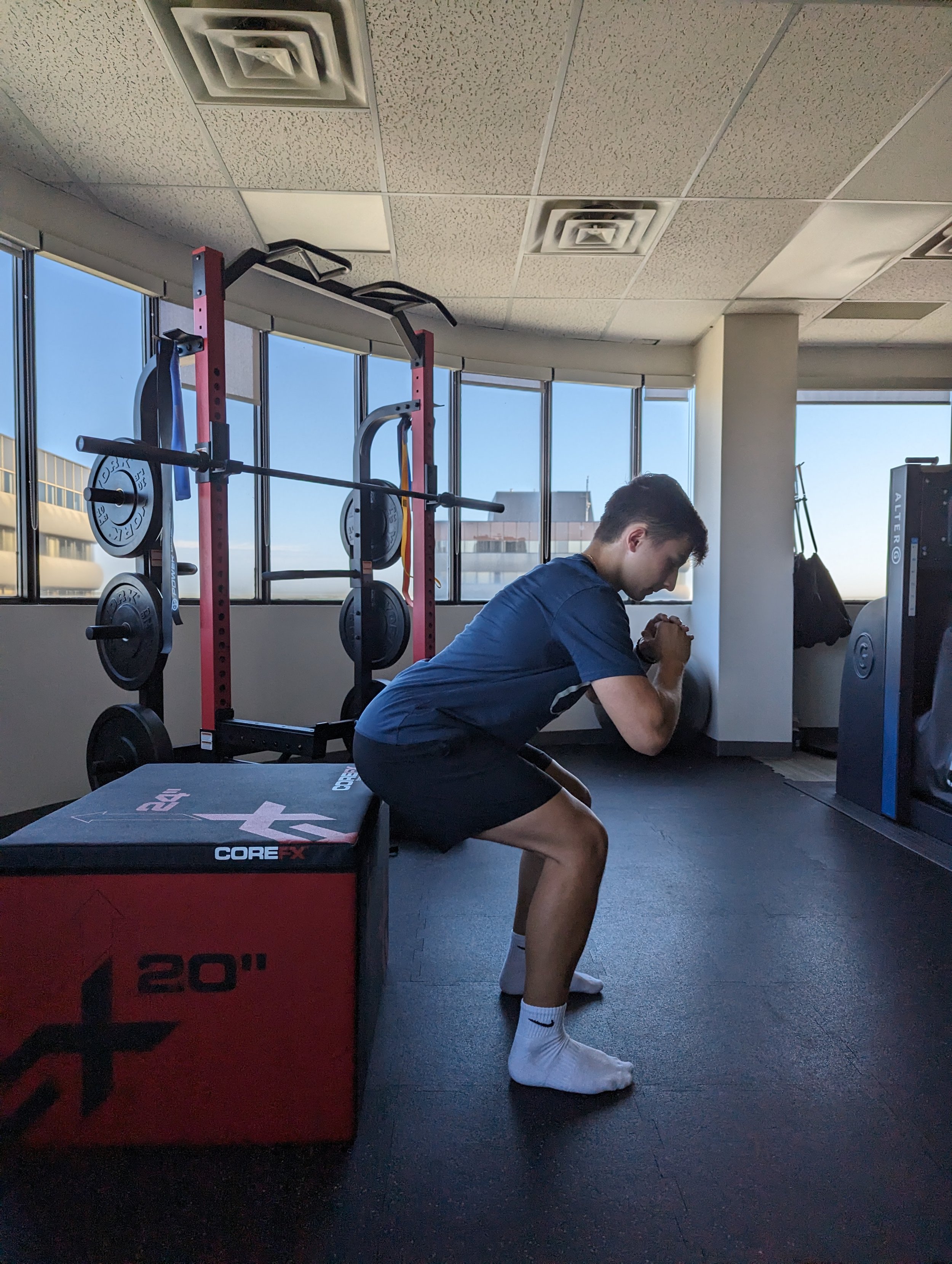 Soccer player squatting on box