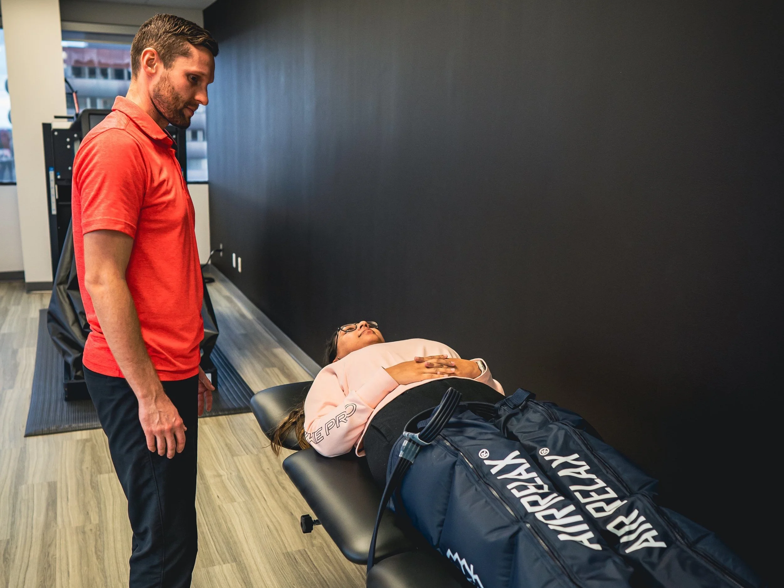 Physiotherapist Helping Patient into Recovery Boots