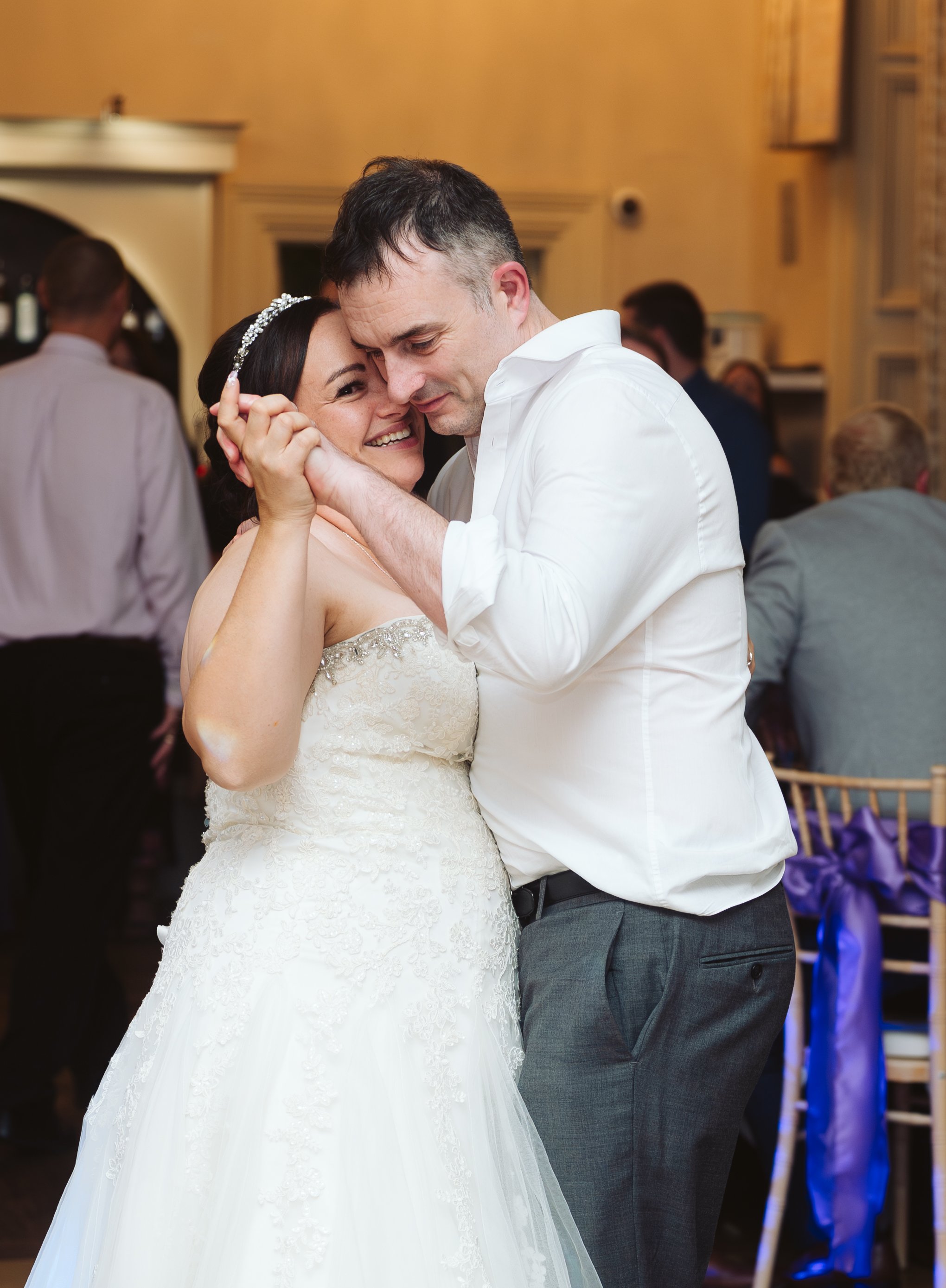 A bride and groom sharing a dance at their wedding reception.
