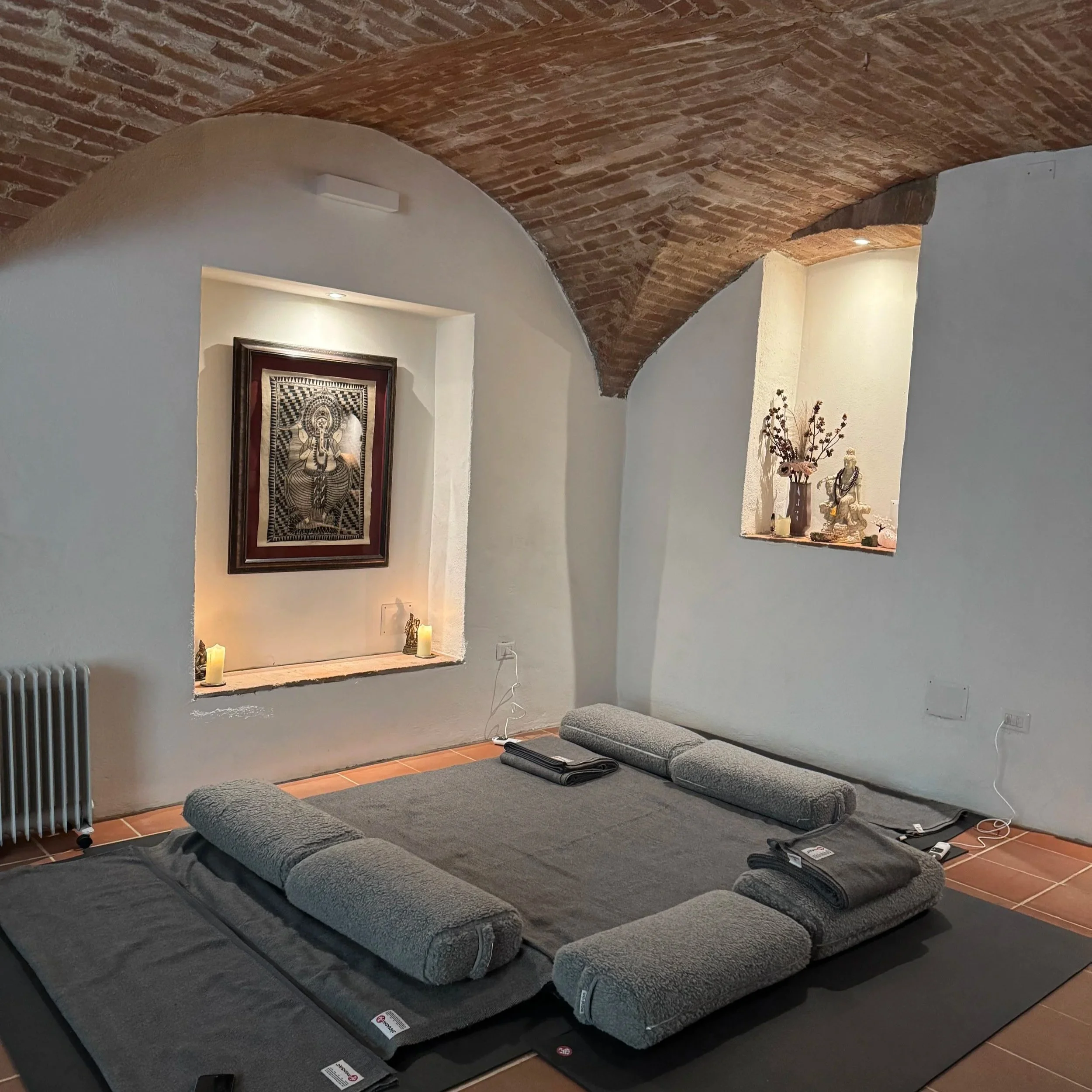 Thai Yoga Massage performed on a cushioned, heated mat on the floor.