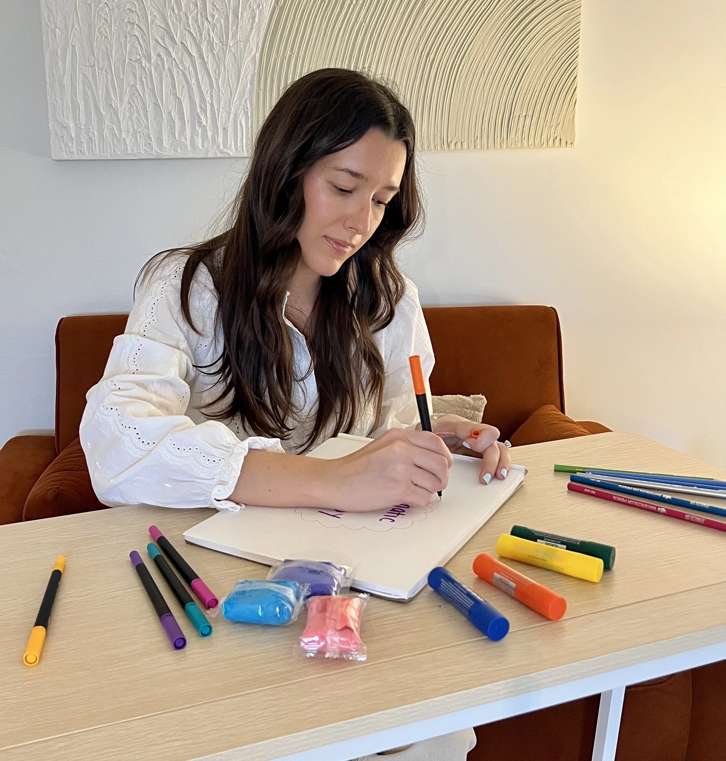 Miami Art Therapist using markers, air dry clay and paint sticks to process emotions.