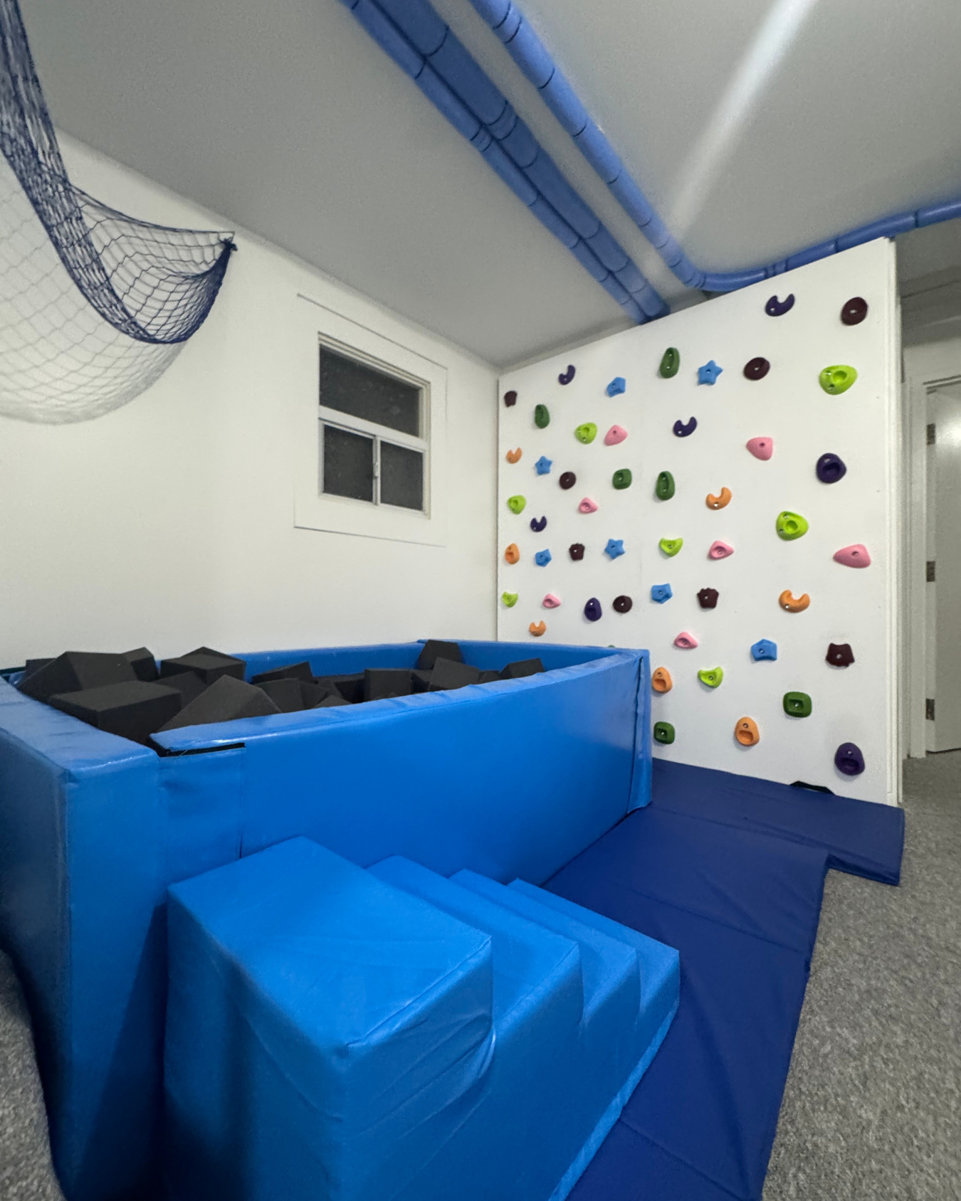 Our rock wall and foam pit at Main Street!