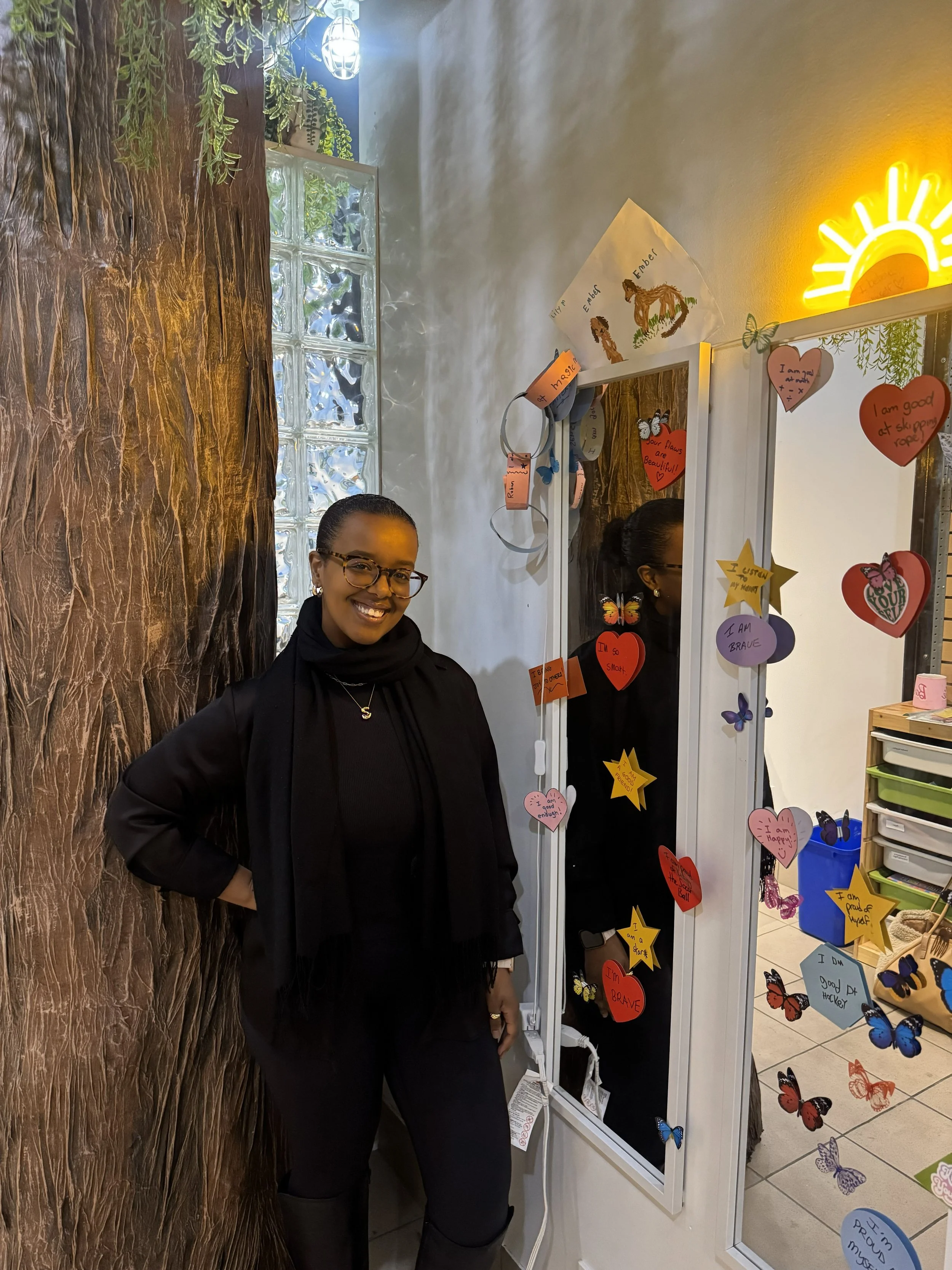 Safia admiring our affirmation wall at Main Street