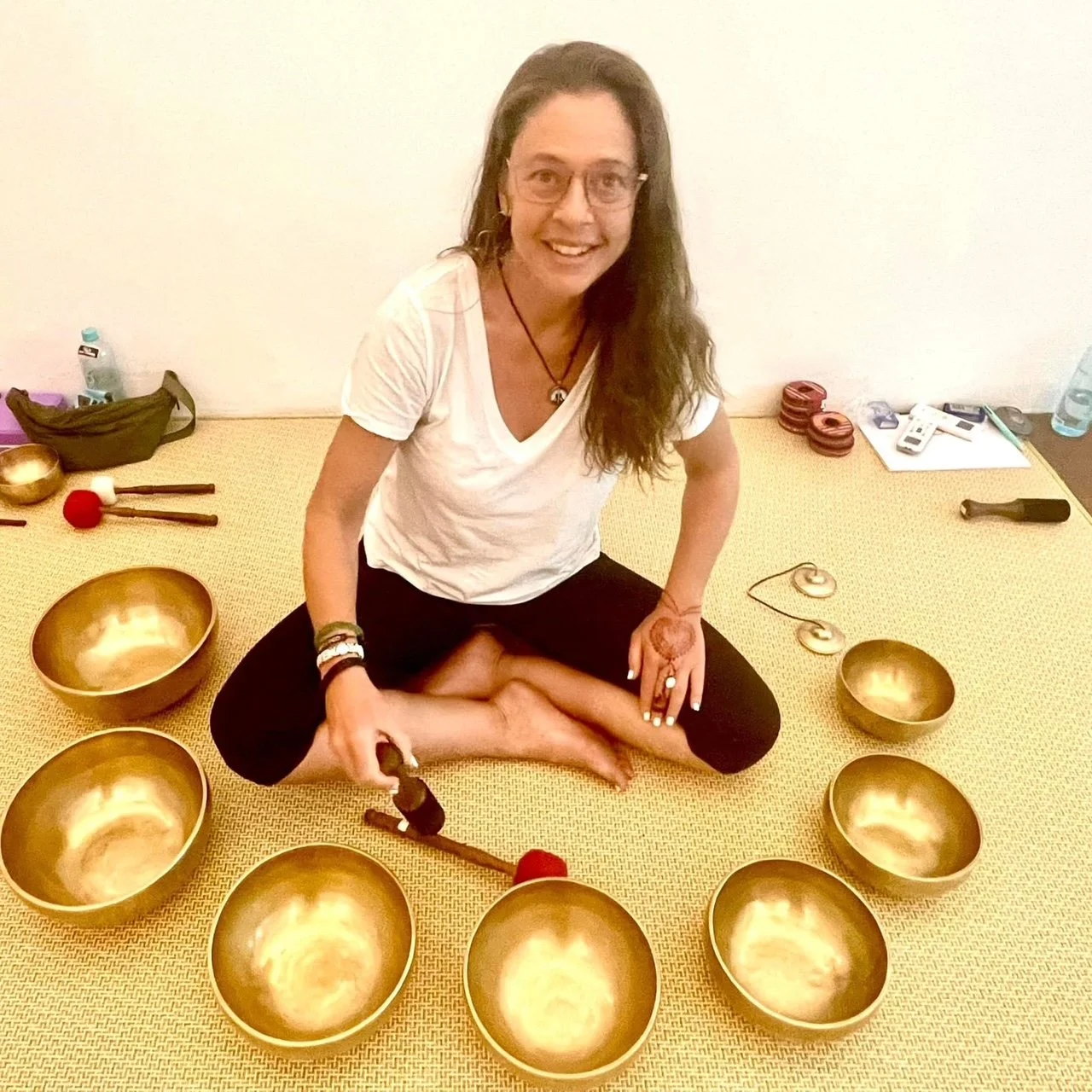 "Our instructor prepares for a session of gentle yoga featuring sound healing"
