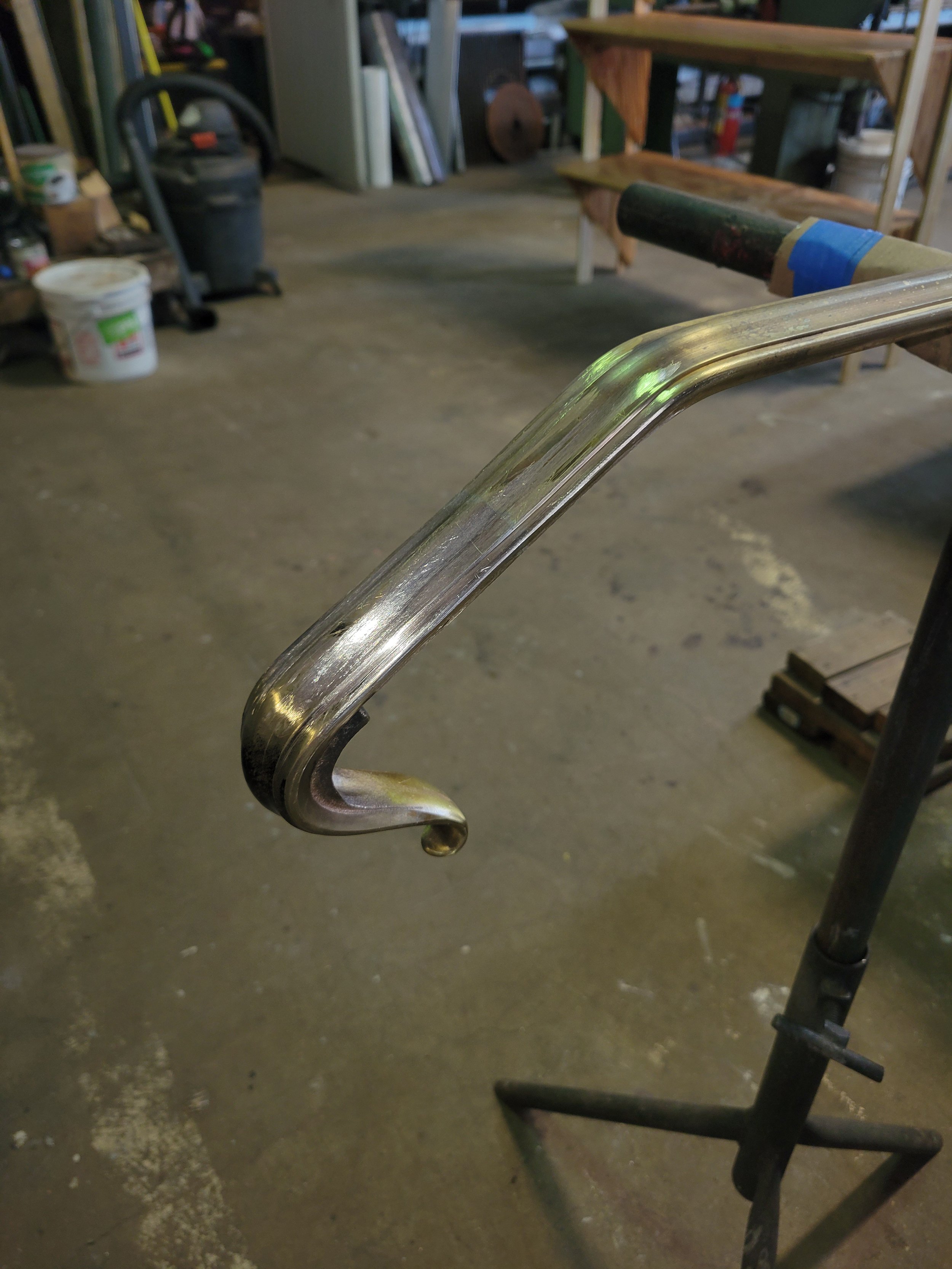 The fabrication process for brass railings includes hours of hand filing and sanding for seamless transitions between the cast volutes and molded bar cap railing.