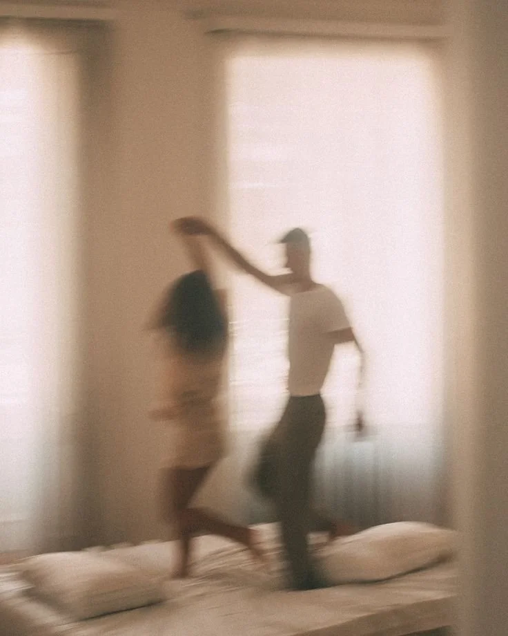 couple dancing on bed