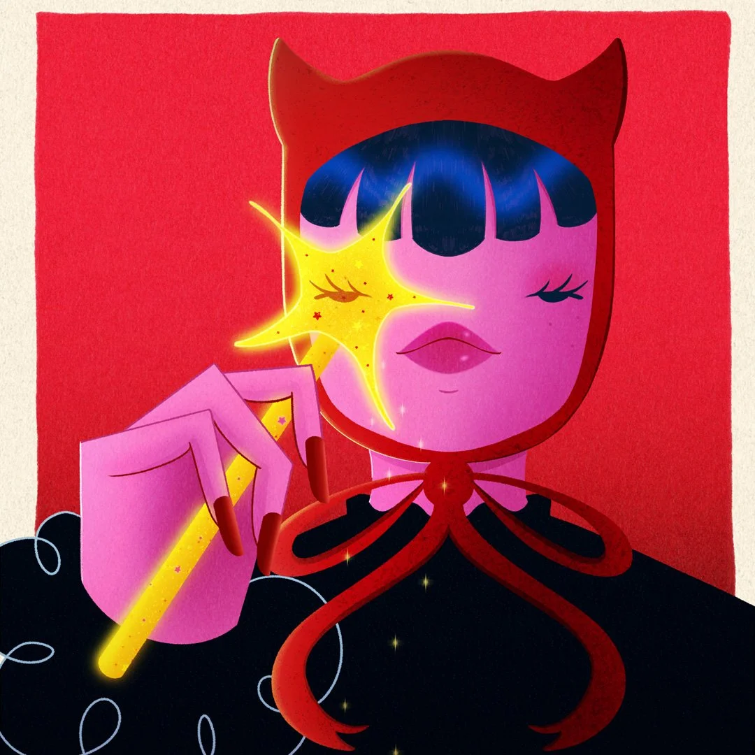 Editorial portrait of a woman wearing a red hood, holding a glowing star-shaped wand near her face against a red background.