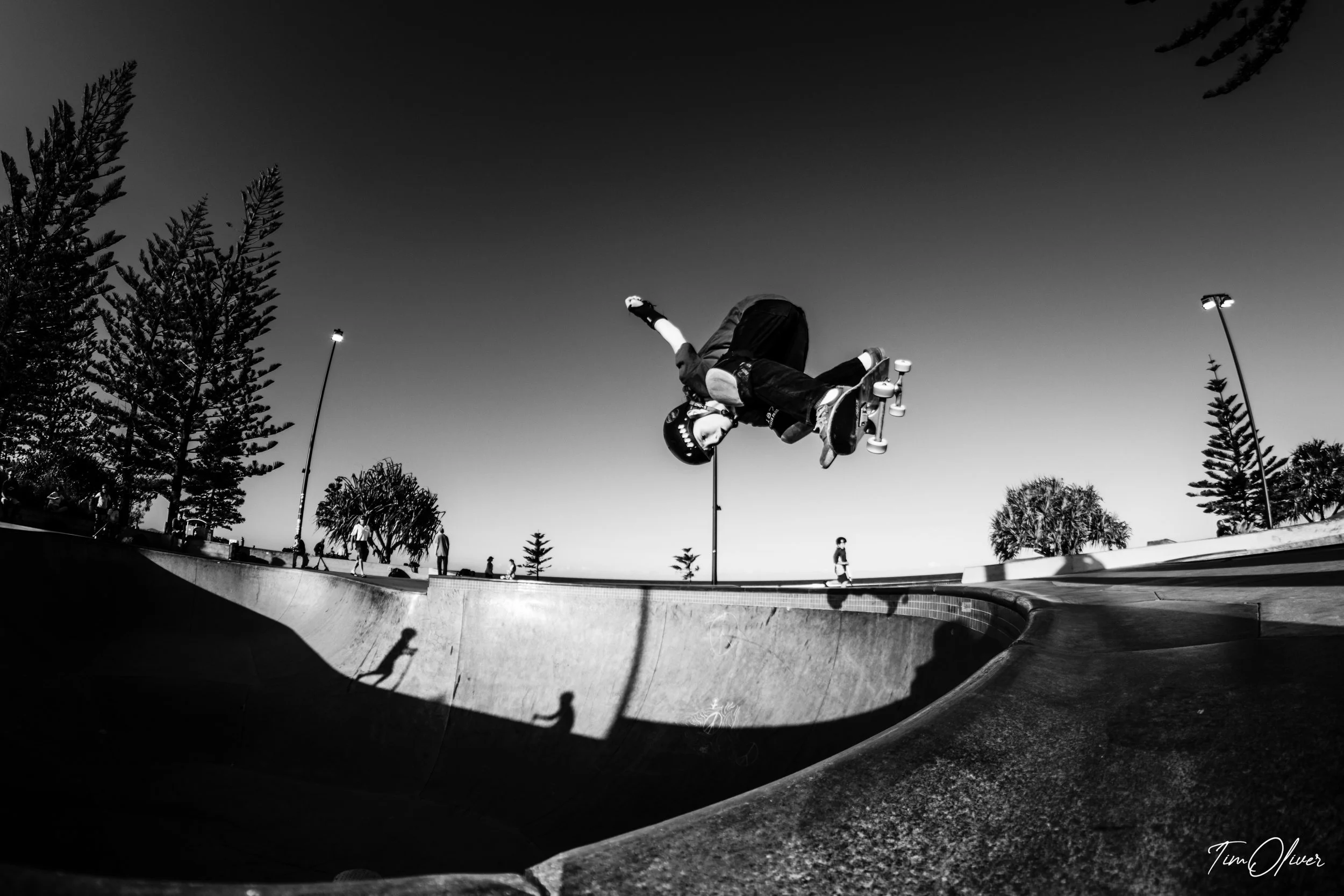 Young skateboarder at Alexandra headland skate park getting air at in black and white