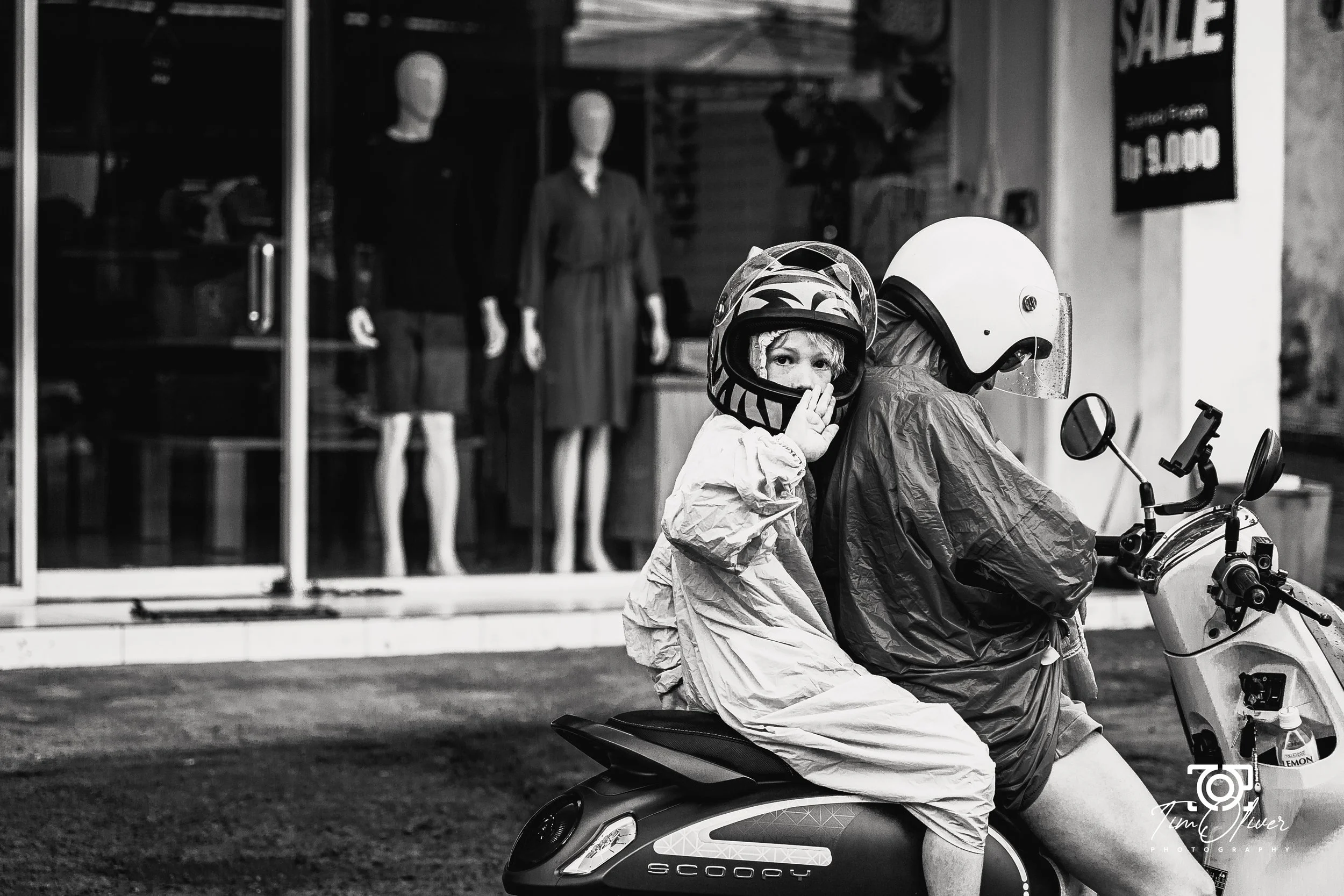young boy on the back of a scooter in Bali