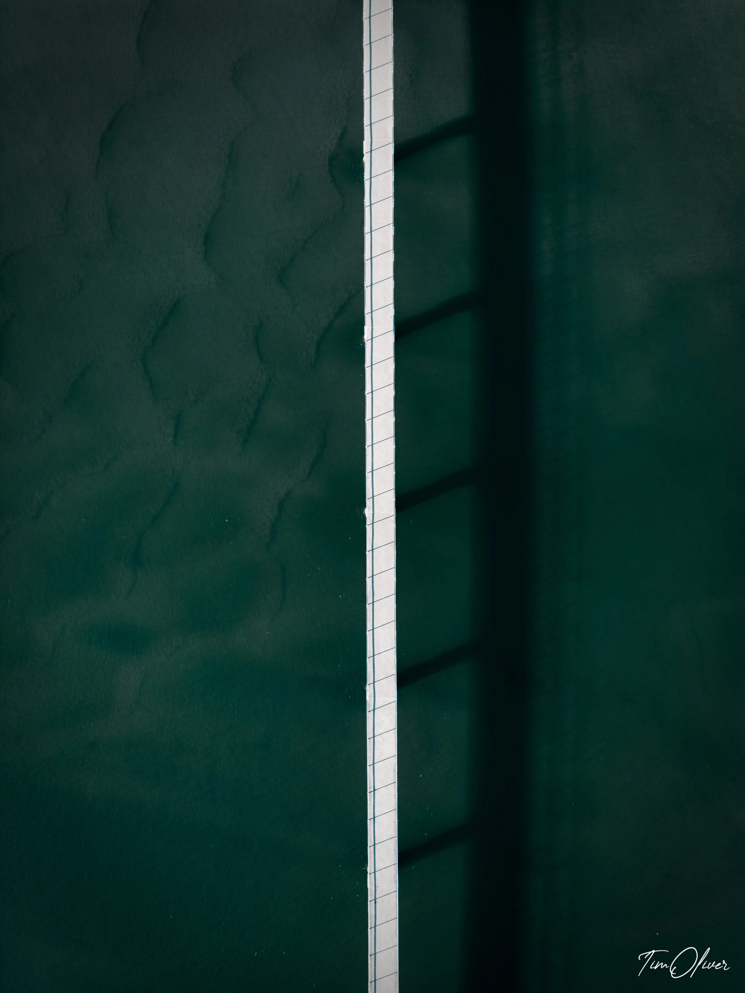 minimalist drone photo of a bridge over water at Maroochydire