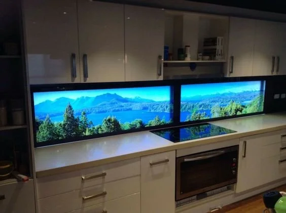 Mountain lake print on a backlit glass kitchen backsplash