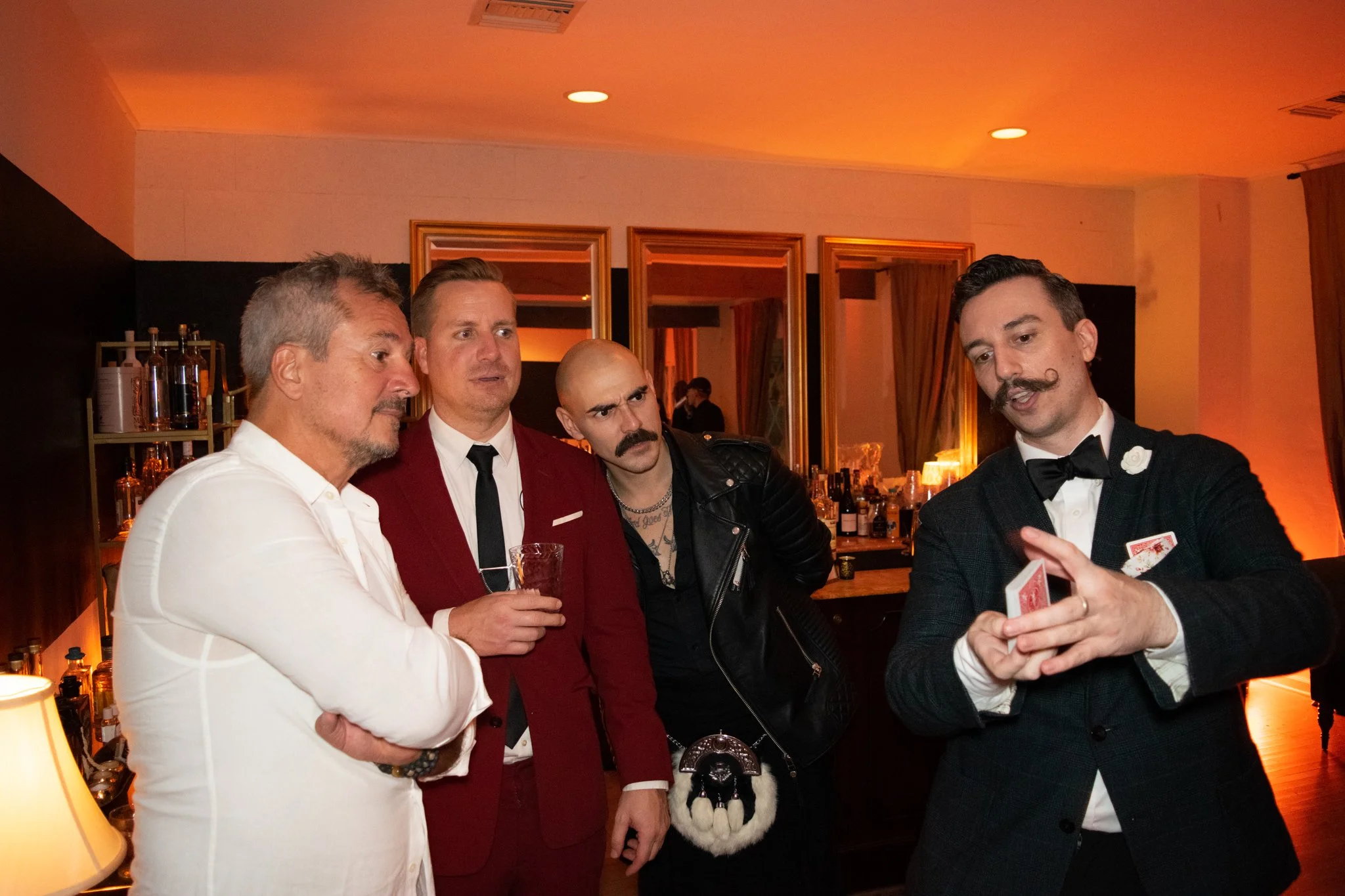 Jeff Black performs close-up card magic for guests at an upscale private party.