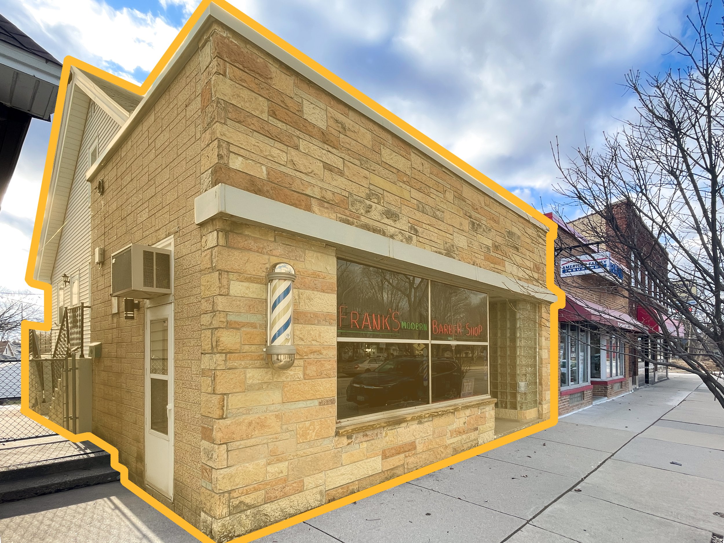 A brick retail storefront occupied by a barbershop attached to a 3 bedroom apartment
