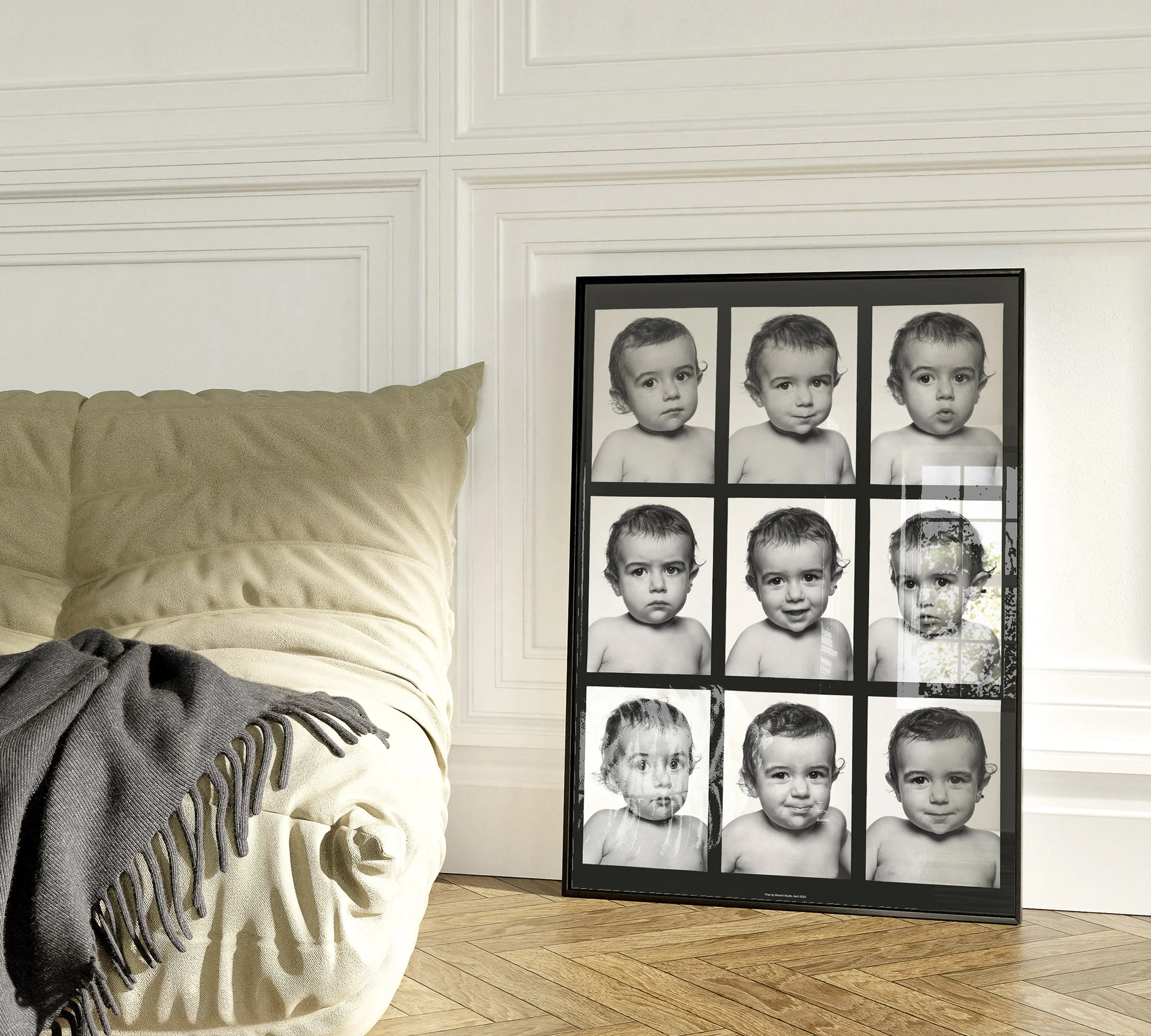 Framed black and white photo collage of a young child with various facial expressions, leaning against a white wall next to a beige sofa with a dark grey blanket on it.