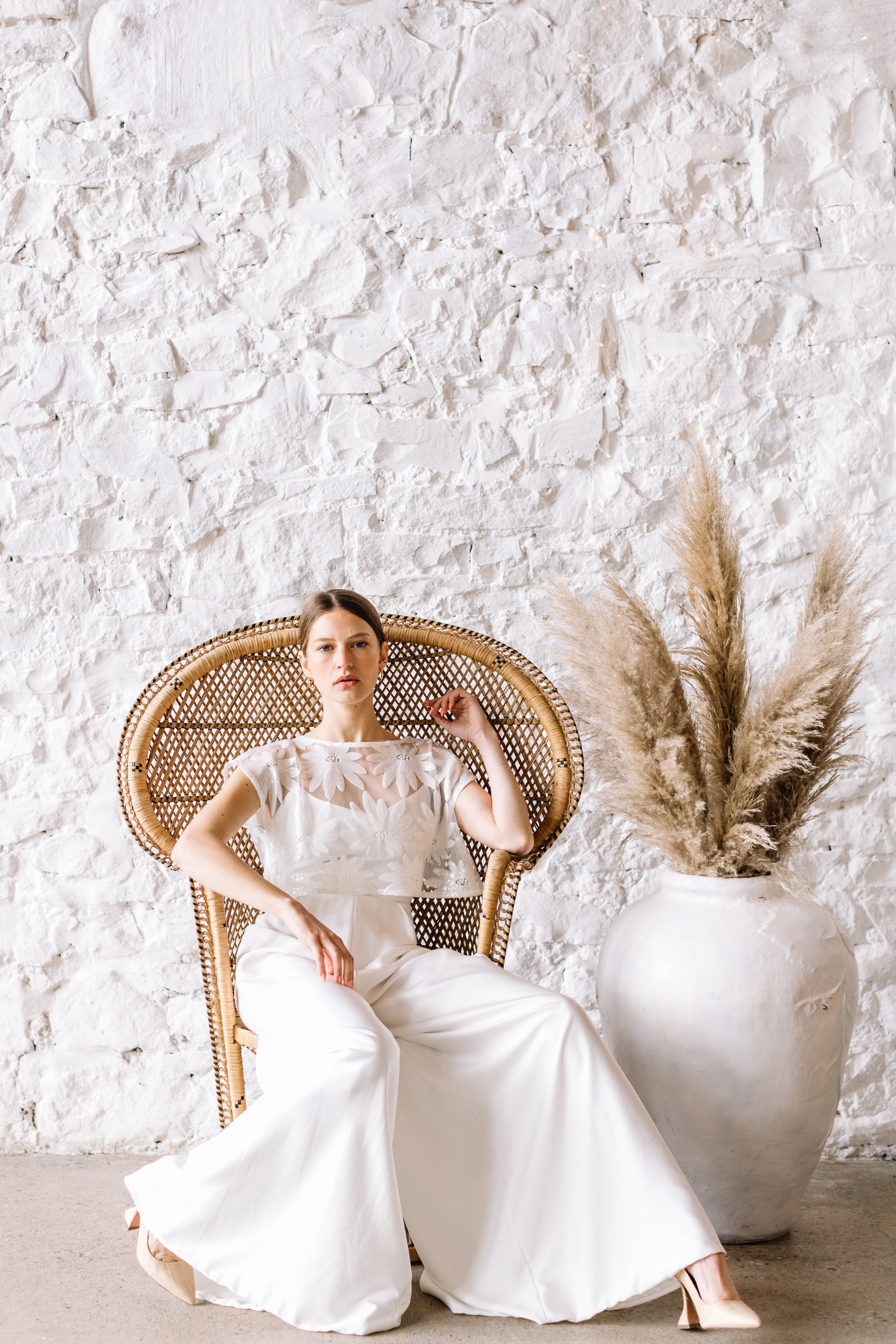 Bride-sitting-peacock-chair-with pampas.jpg