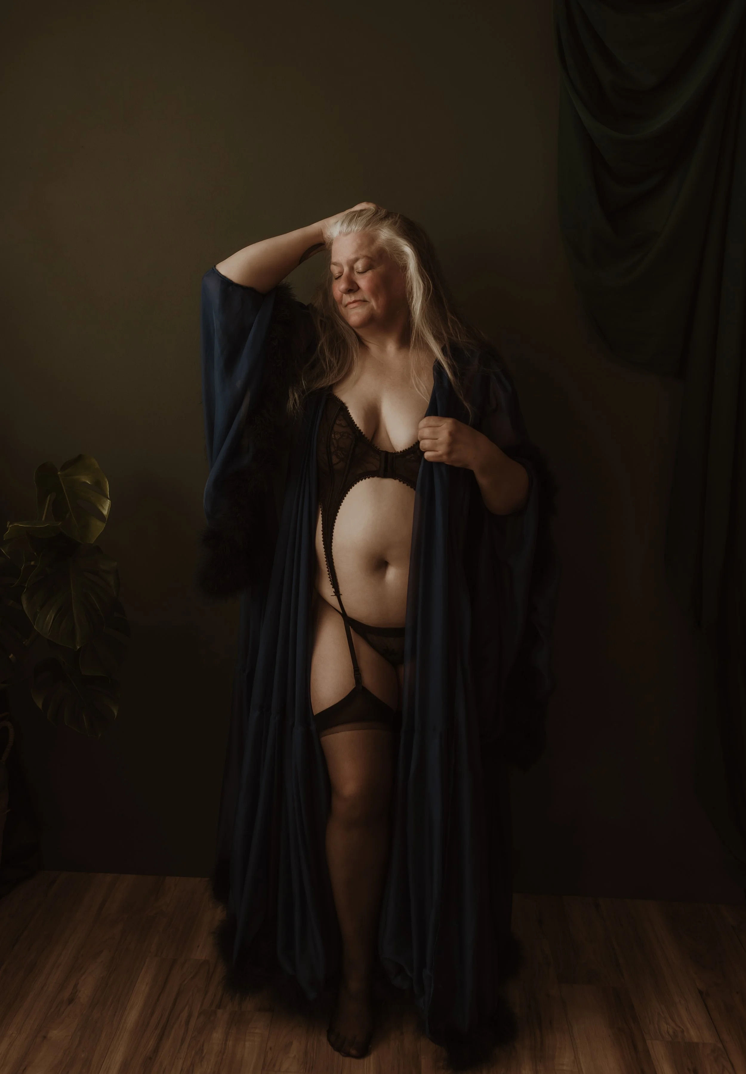 Woman standing proudly with her hand in her long grey hair during a boudoir session at Marieke Captures Glasgow — empowerment photography Scotland