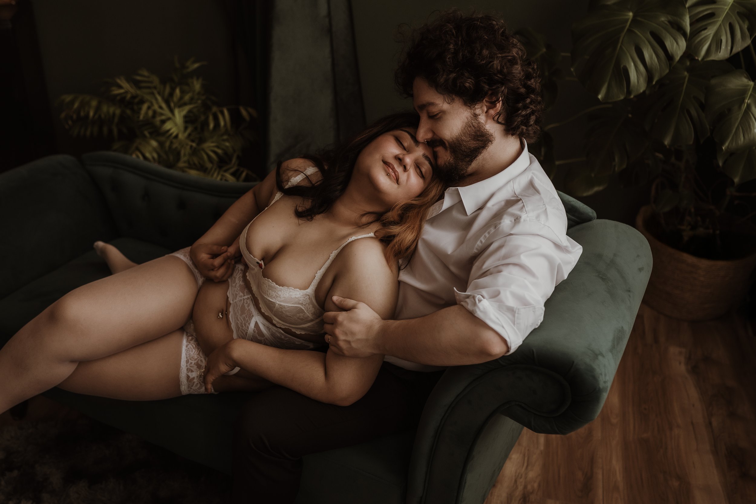 A couple sharing a quiet, tender moment during their couples boudoir session at Marieke Captures studio in Glasgow, Scotland.
