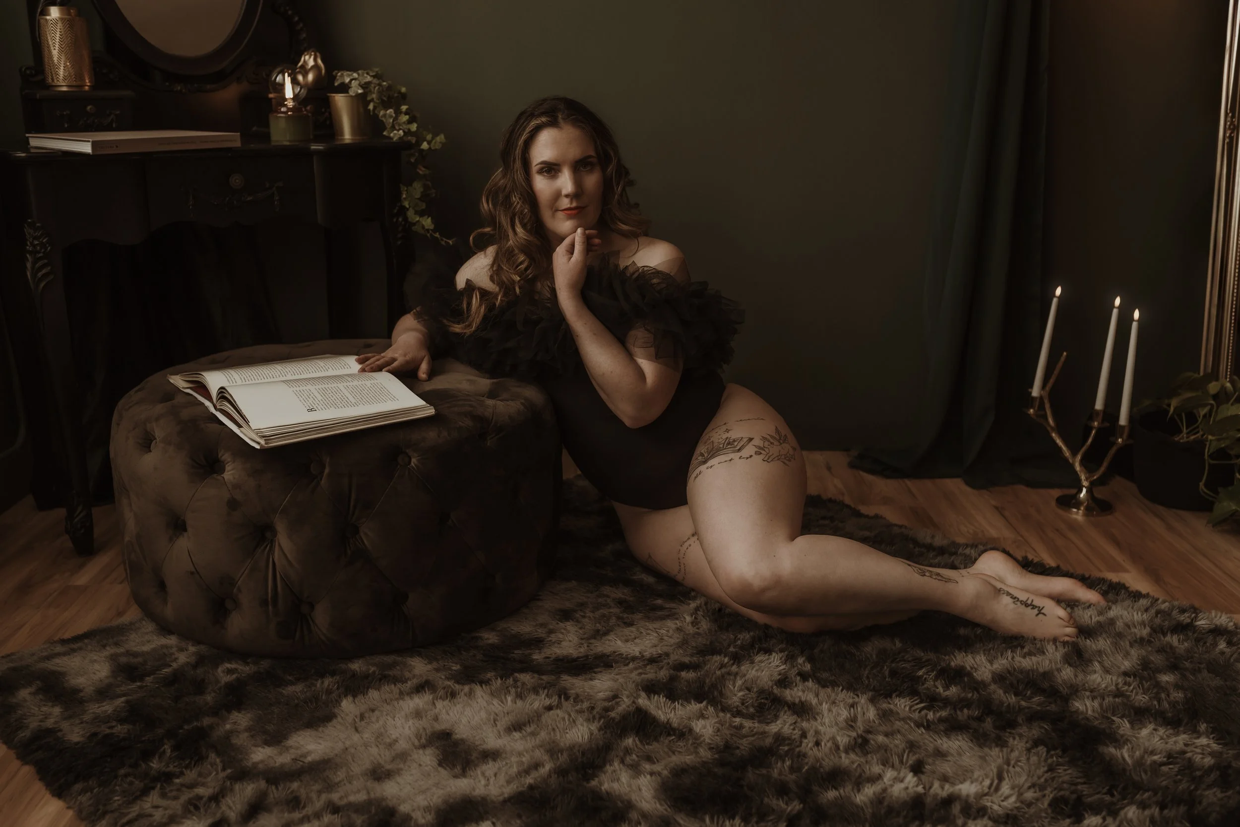 Relaxed boudoir portrait with an open book in the candlelit Marieke Captures studio, Glasgow, an unhurried experience
