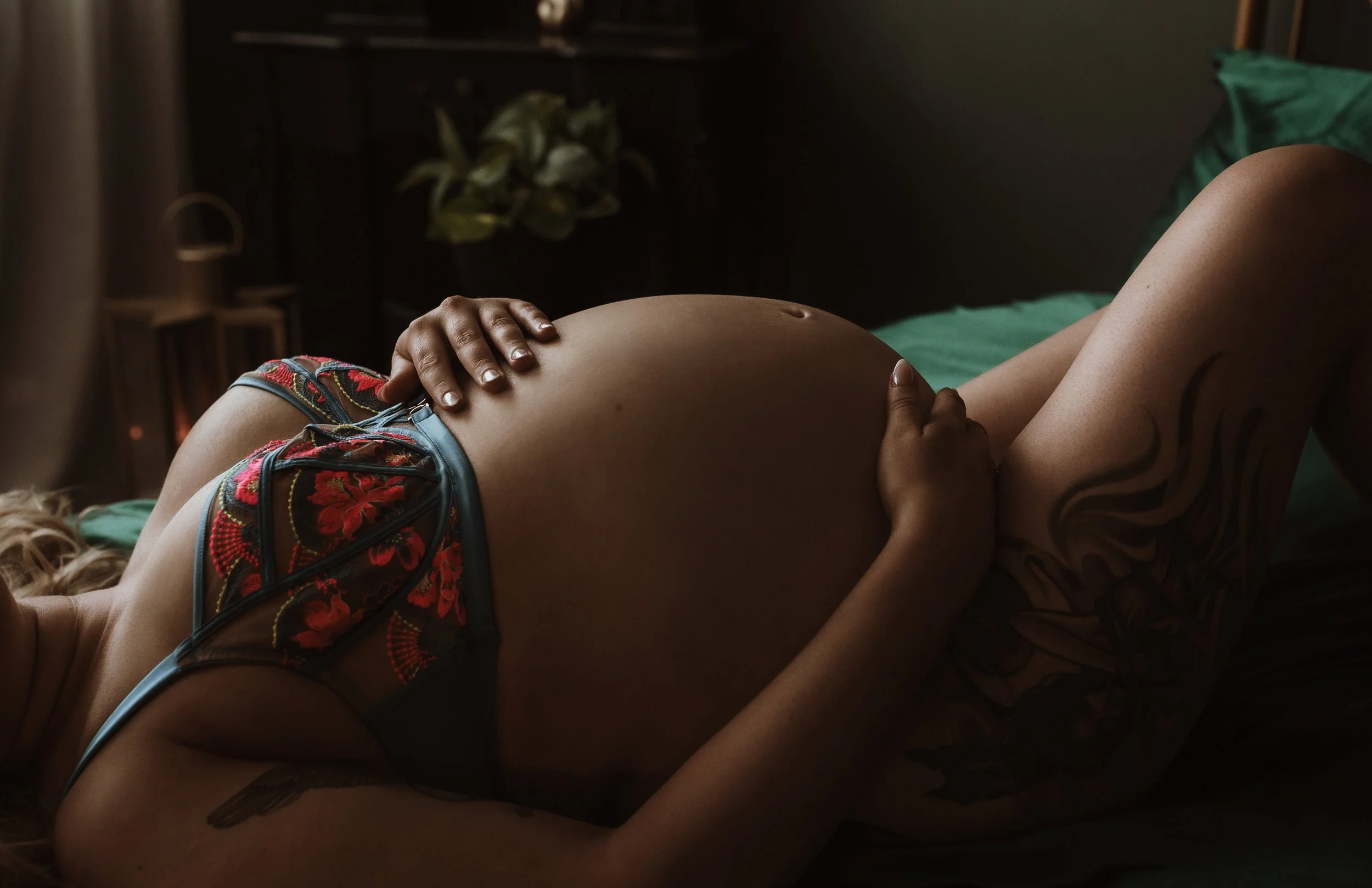 Close-up detail of pregnancy bump during maternity boudoir photography session at Marieke Captures studio Glasgow — intimate and artistic studio maternity portrait with embroidered lingerie