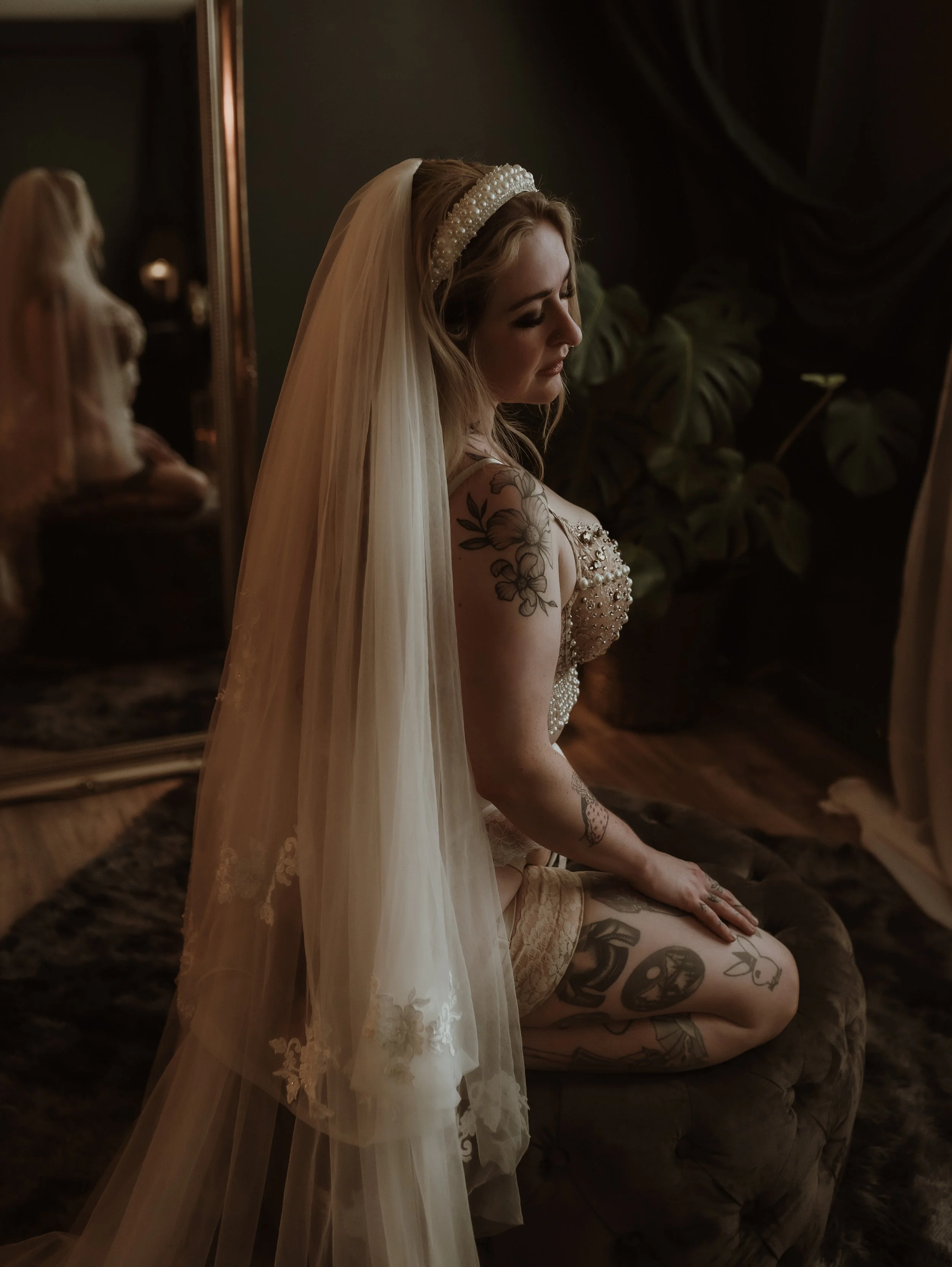 Softly lit wedding boudoir portrait of an engaged woman sitting confidently at Marieke Captures studio in Glasgow, celebrating self-acceptance before her wedding day