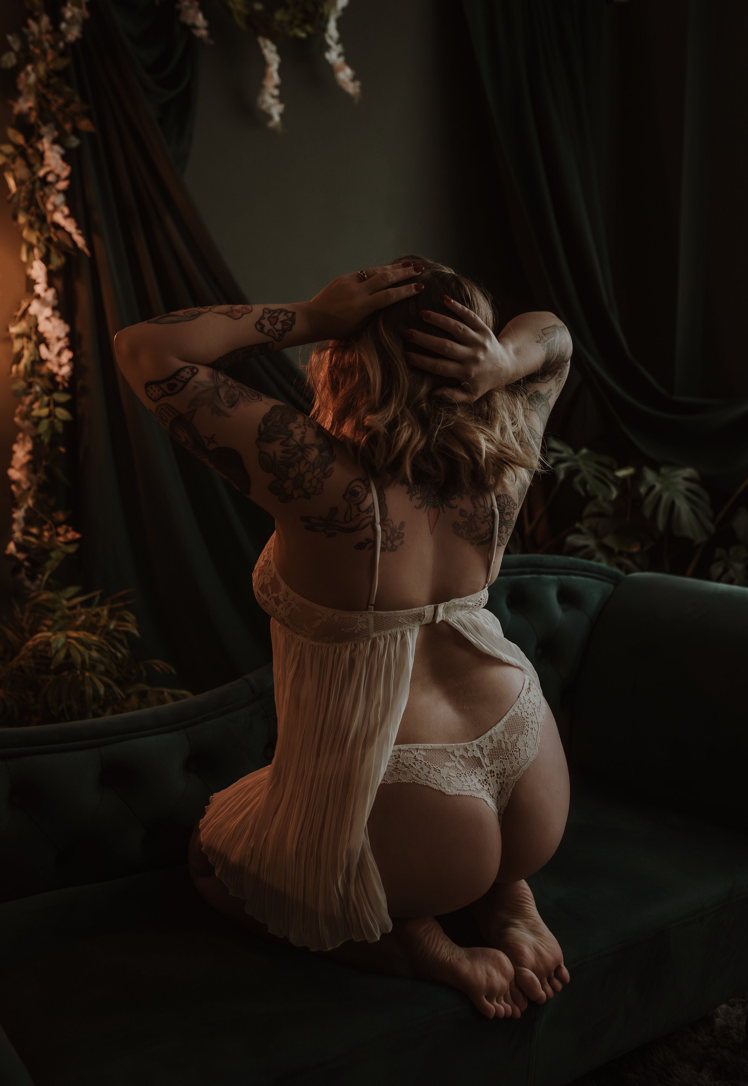 Woman in a soft, intimate pose during a luxury boudoir photography session at Marieke Captures studio in Glasgow