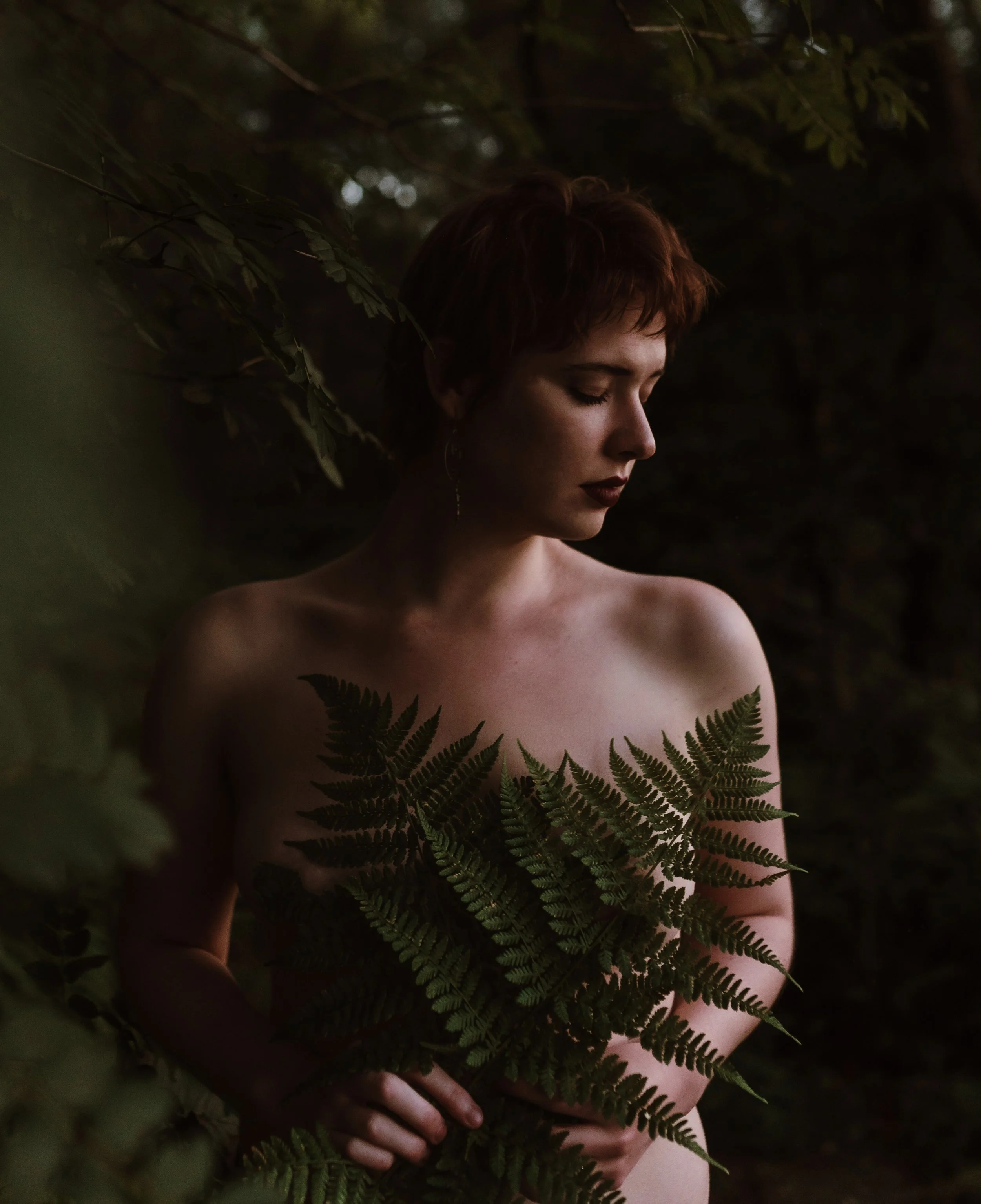 Outdoor boudoir photography Scotland — woman holding ferns in natural light, Marieke Captures