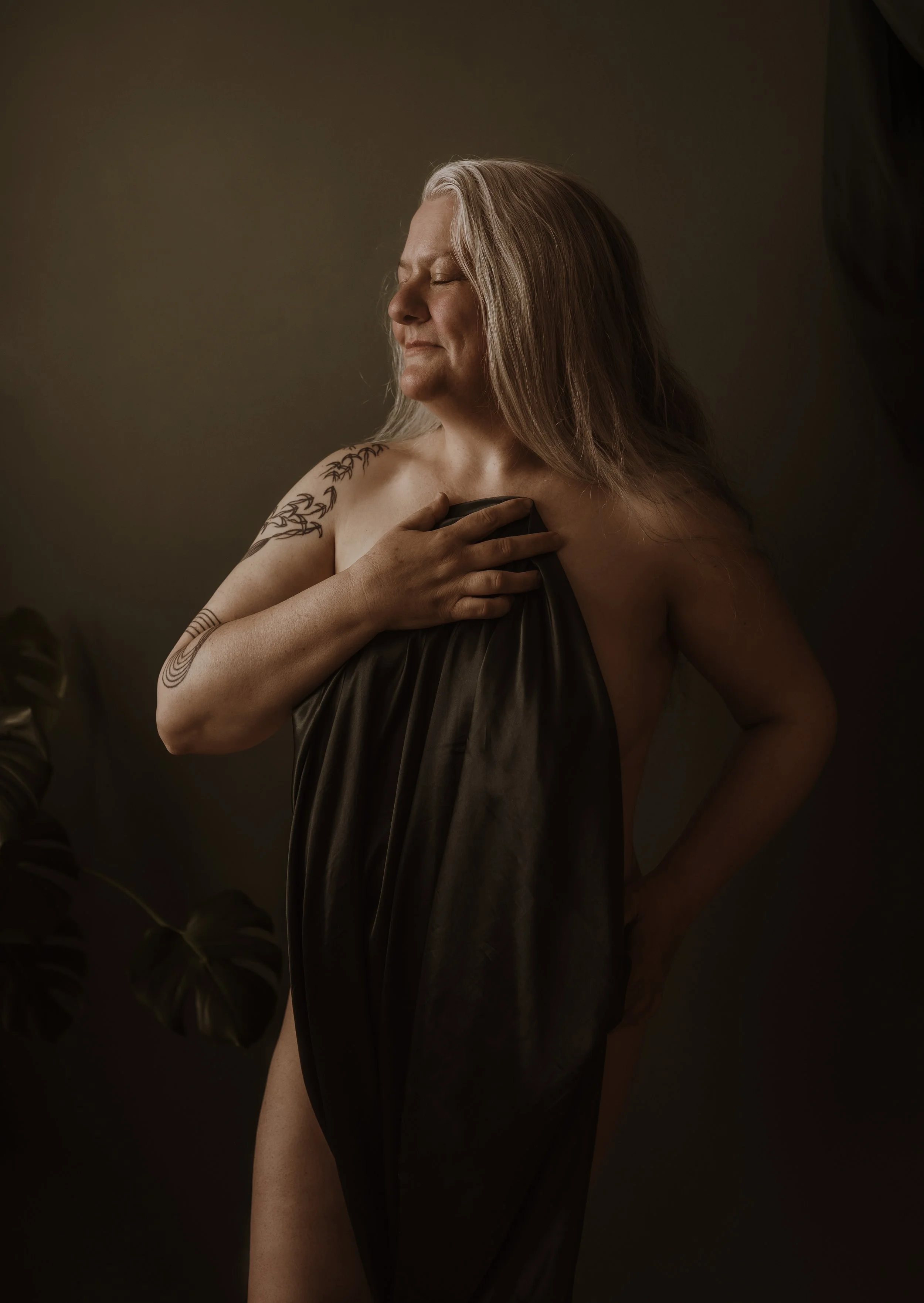 Woman standing proudly wrapped in a sheet during a boudoir photography session at Marieke Captures Glasgow — body confidence empowerment photography