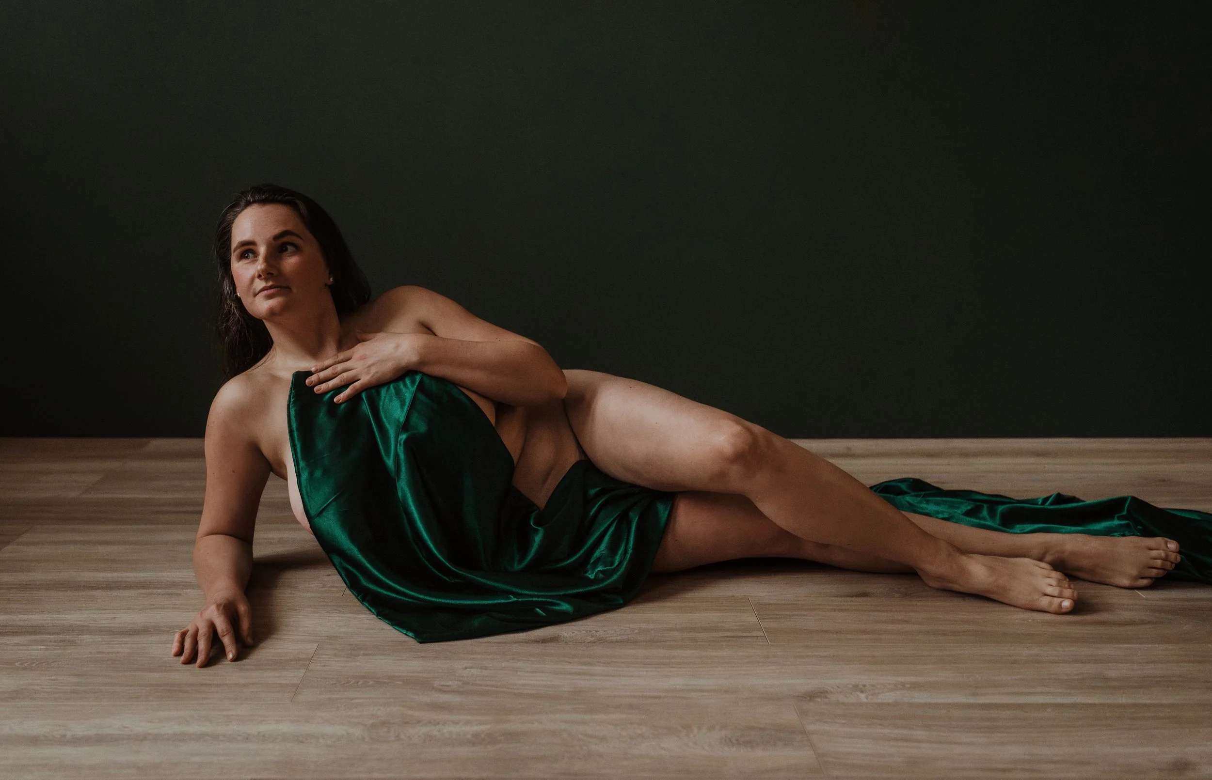 Woman draped in soft fabric during a boudoir photoshoot at Marieke Captures studio in Glasgow — using the client wardrobe sheet for an artistic and elegant boudoir look